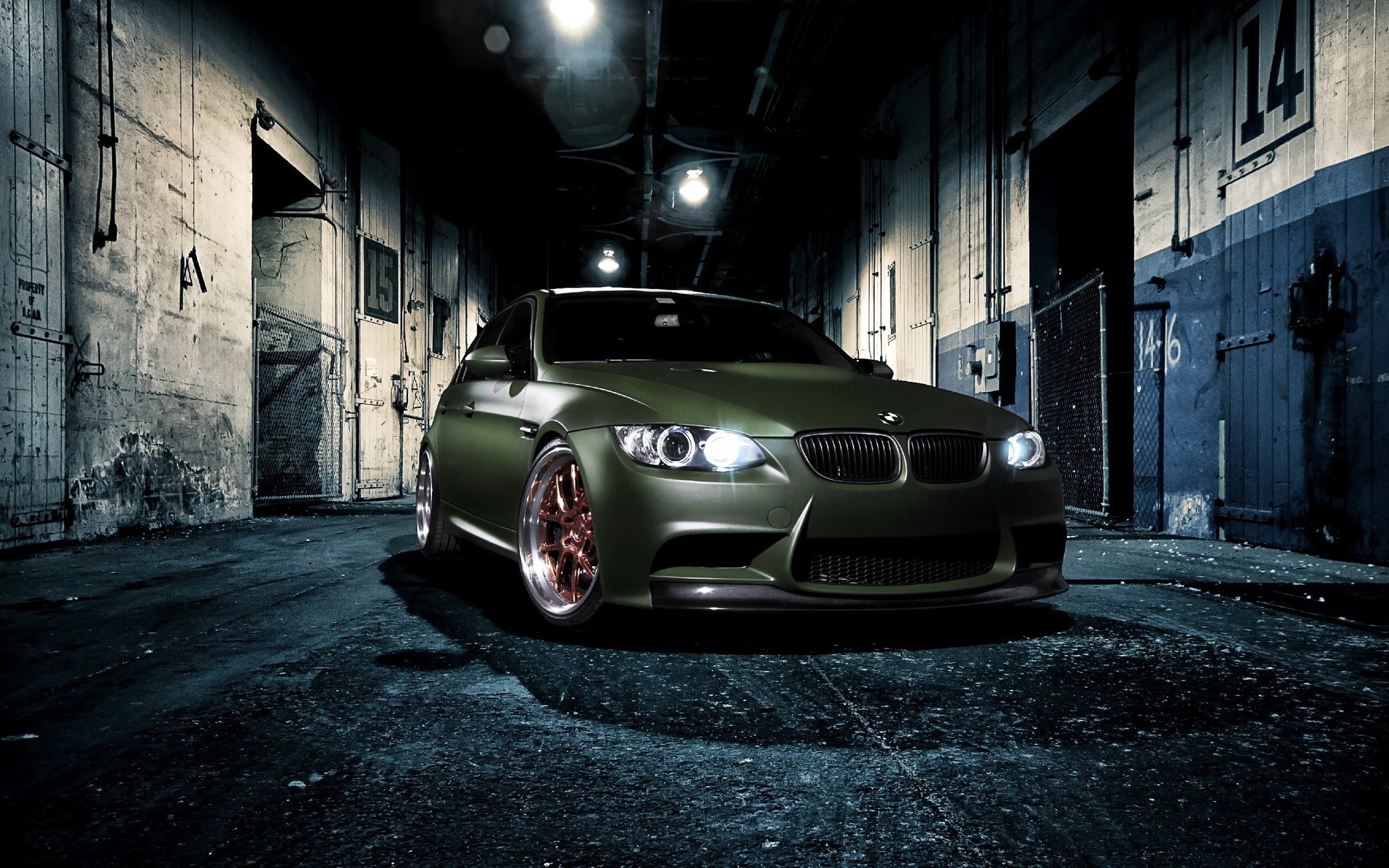 Matte green BMW M3 parked in an industrial alley HD Wallpaper
