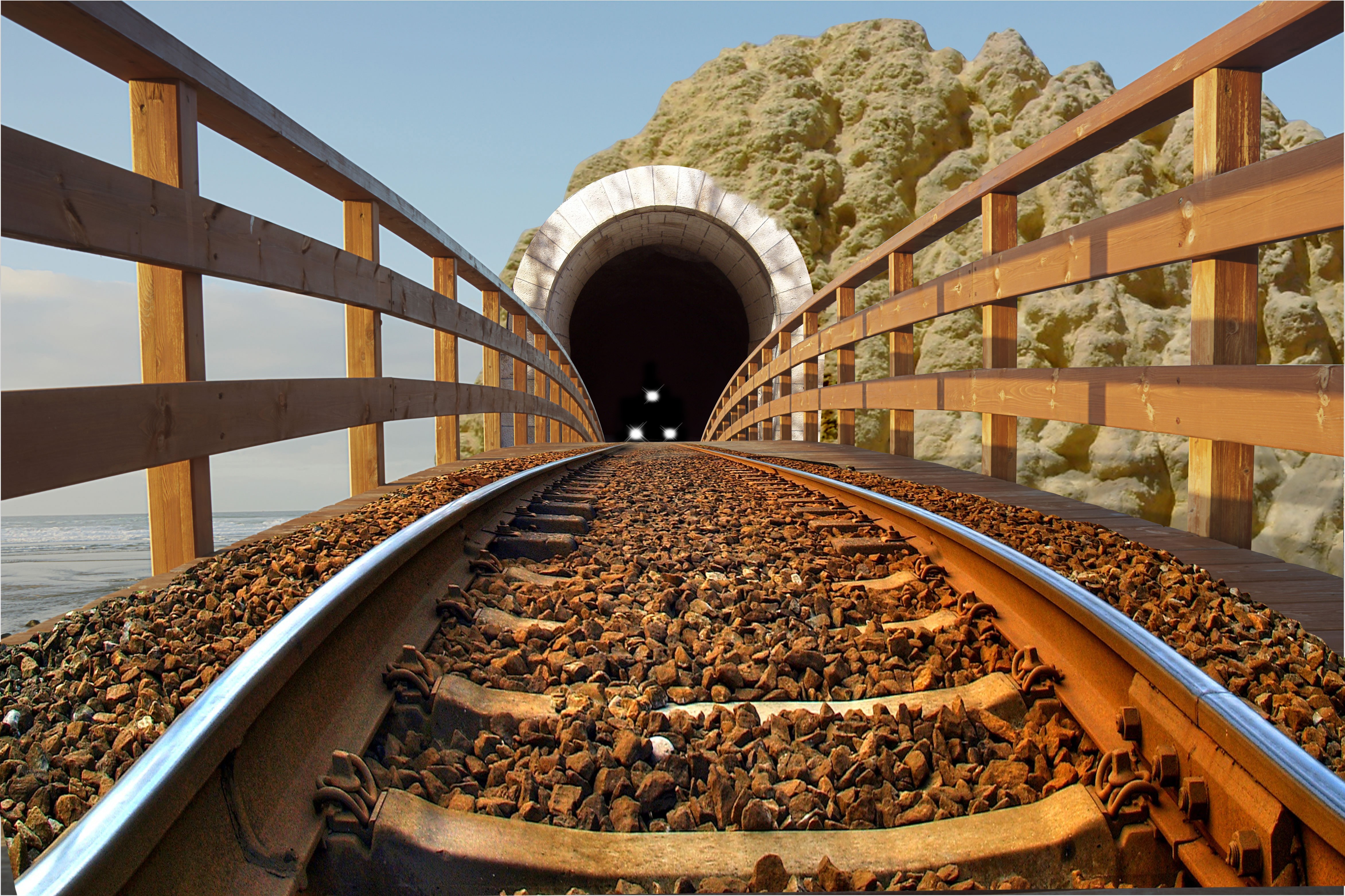 Railroad tracks leading to a tunnel HD Wallpaper