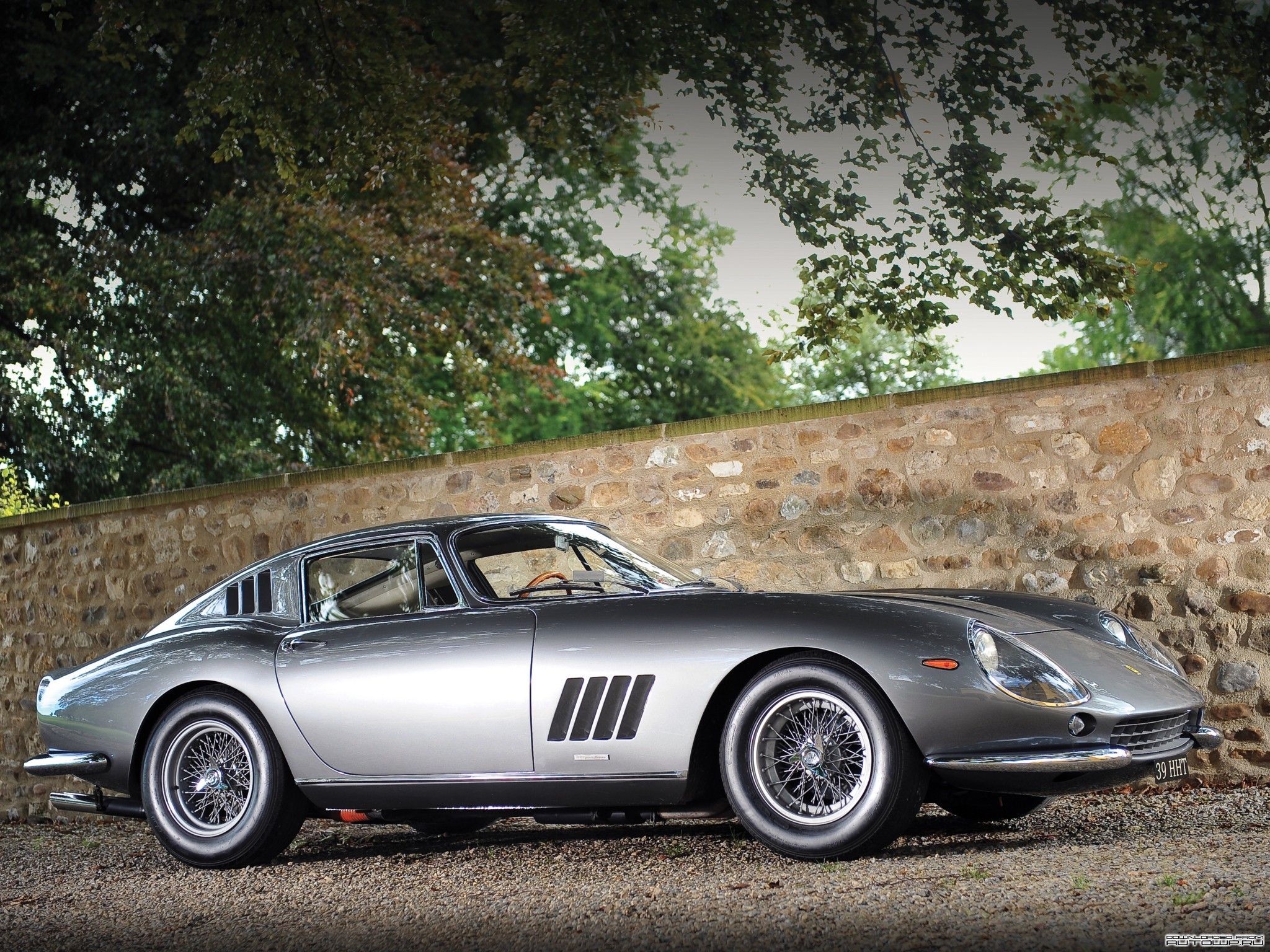 Silver Ferrari 275 GTB/4 parked by a stone wall HD Wallpaper