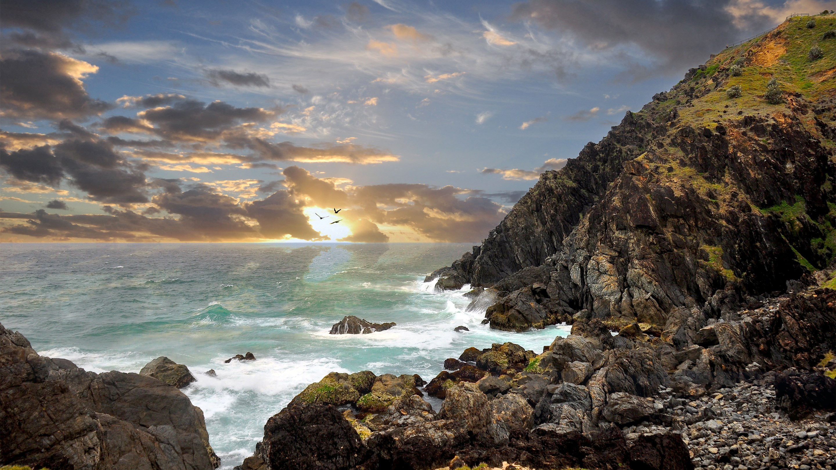 Rocky coastline with ocean waves and sunset sky HD Wallpaper