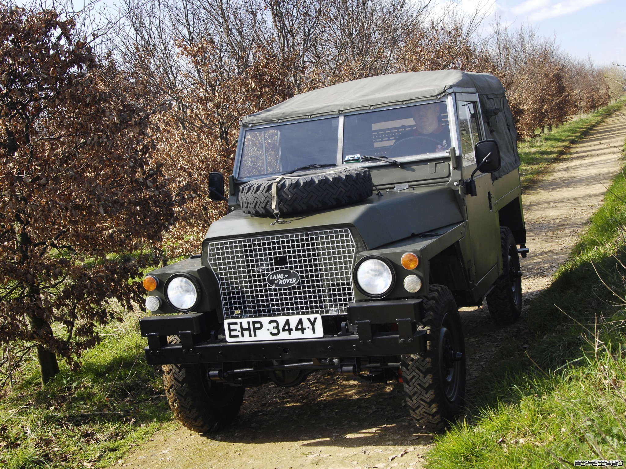 Green Land Rover Series III on a dirt road HD Wallpaper