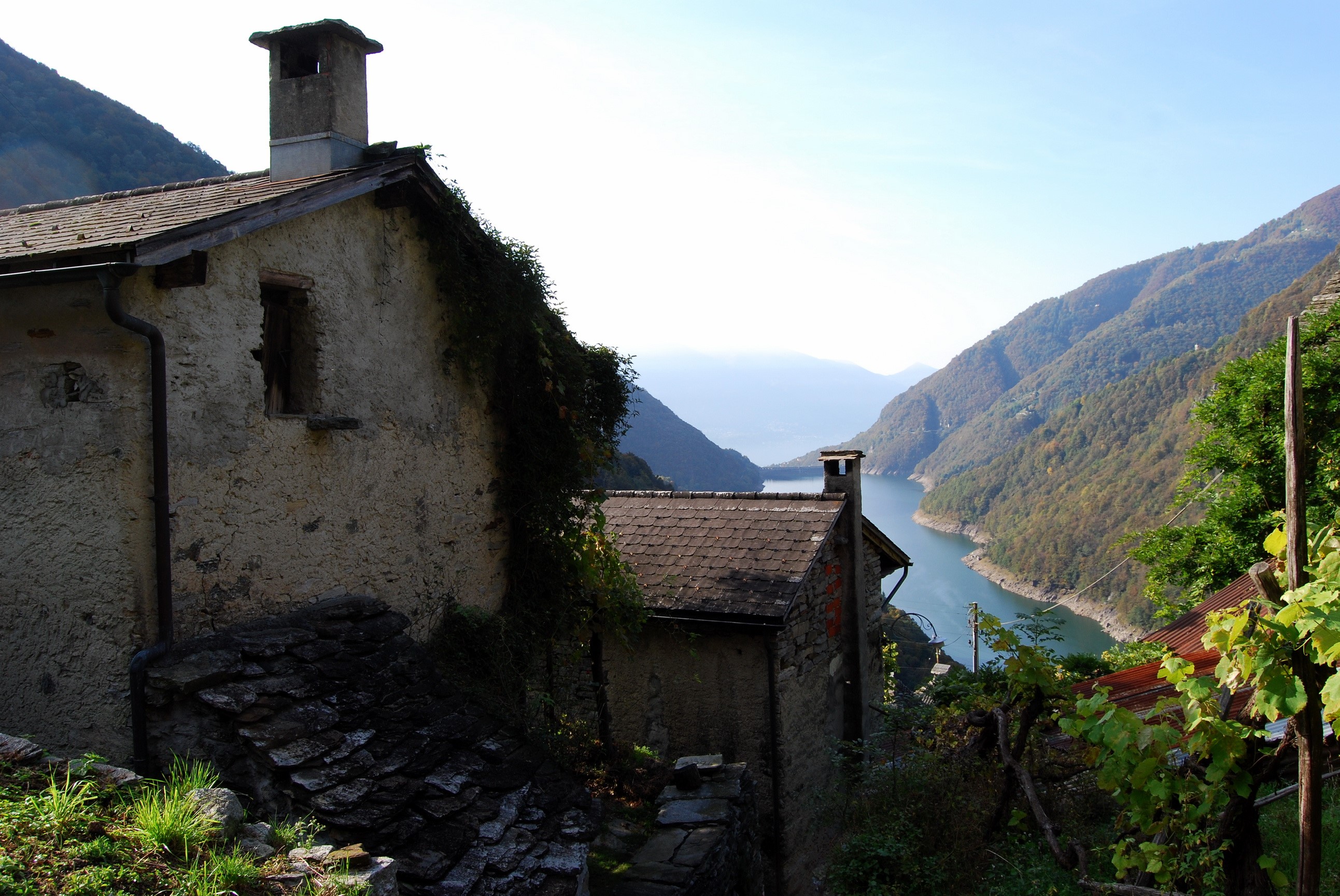 Houses overlooking a lake in the mountains of Ticino, Switzerland HD Wallpaper