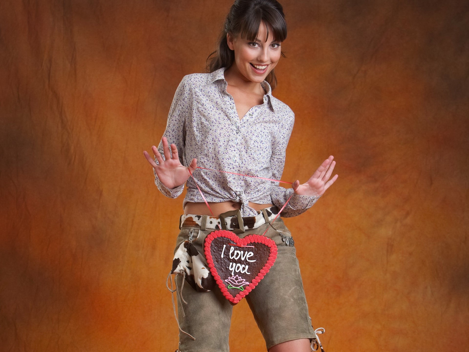 Smiling Woman in Casual Shirt and Shorts with Heart Sign HD Wallpaper