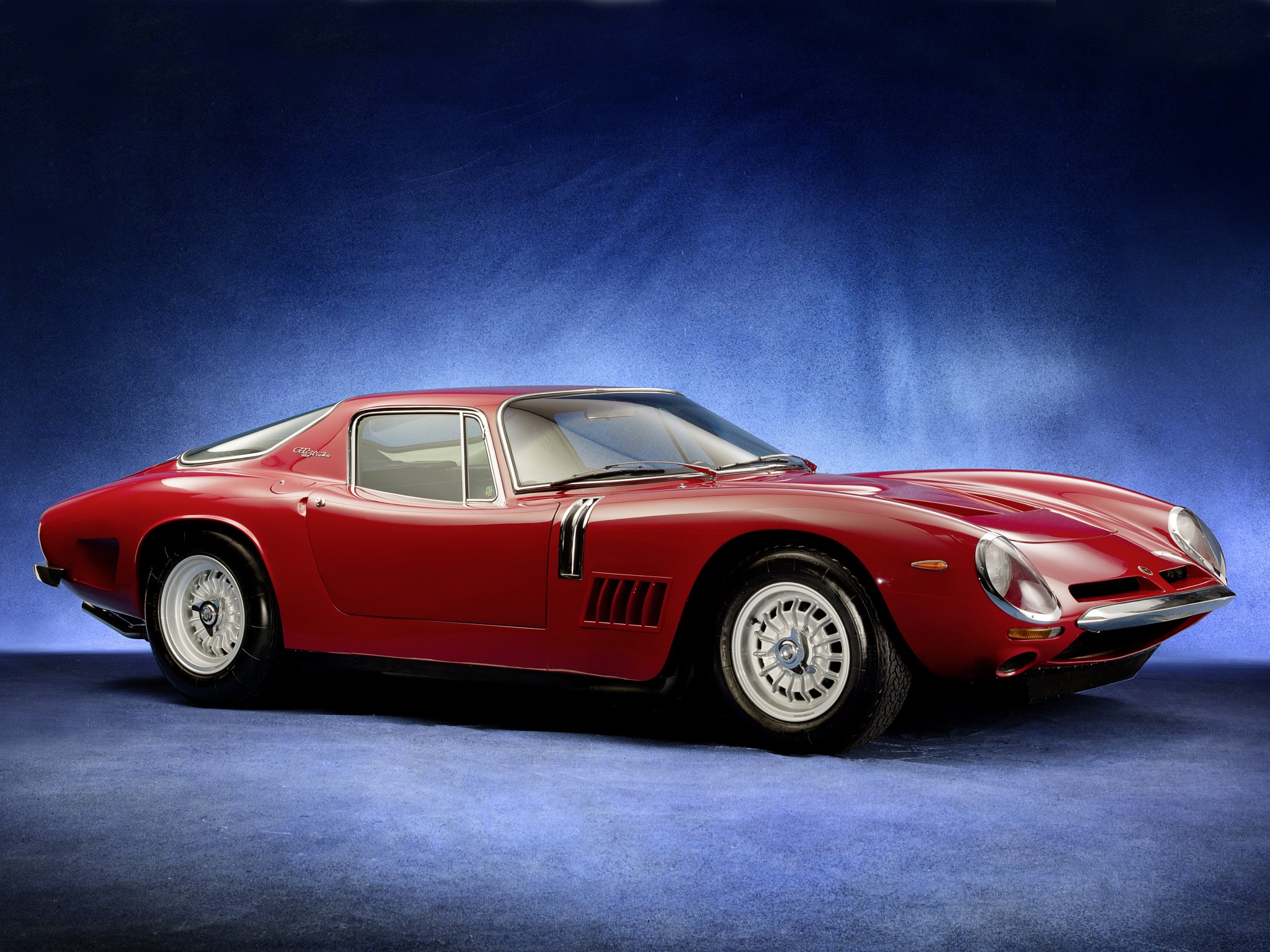 Red Bizzarrini sports car on blue background HD Wallpaper