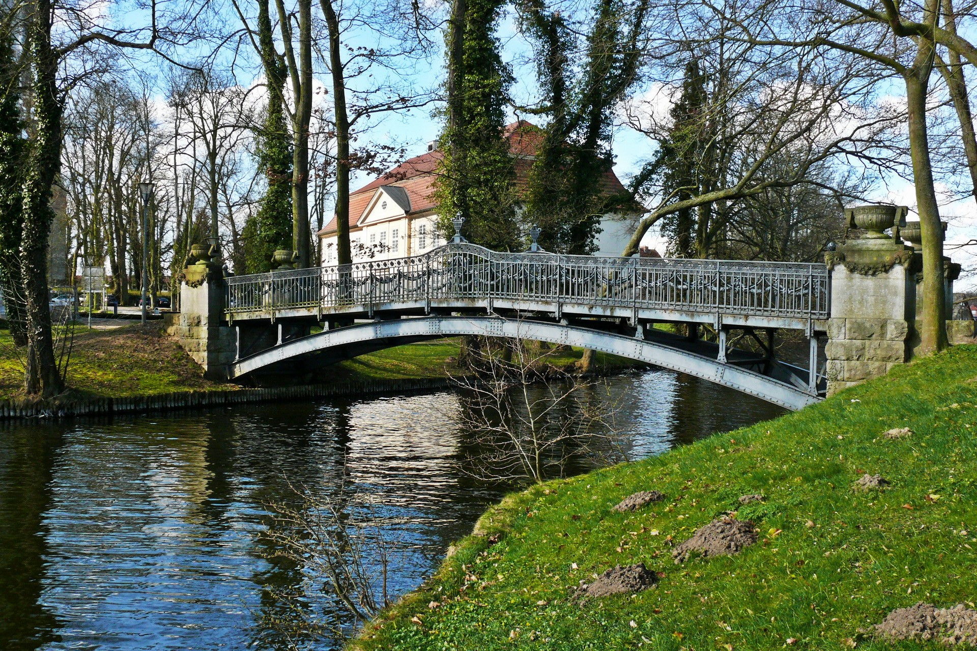 Ornate bridge over a canal with a building in the background HD Wallpaper