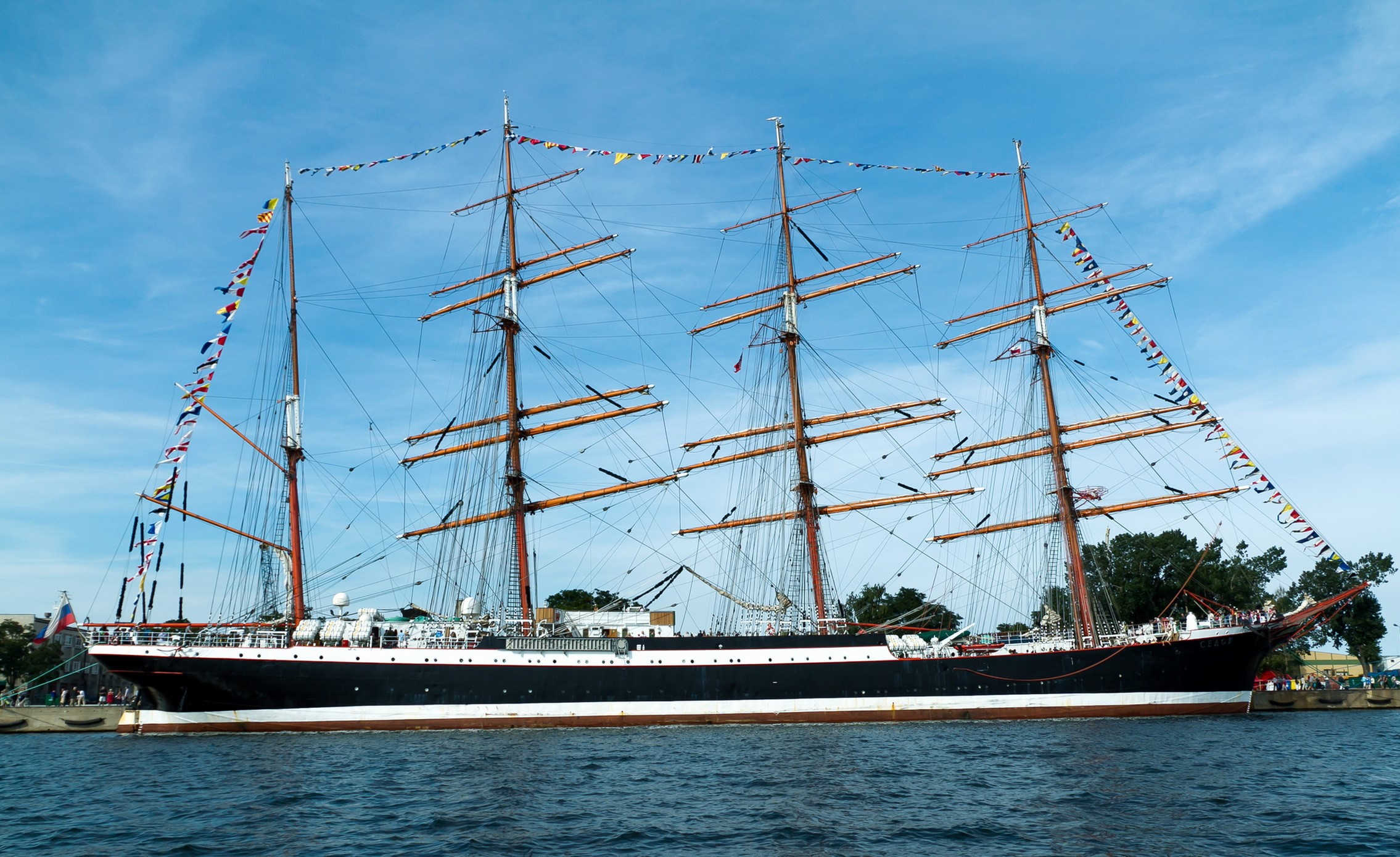 Tall ship with flags sailing on the water HD Wallpaper