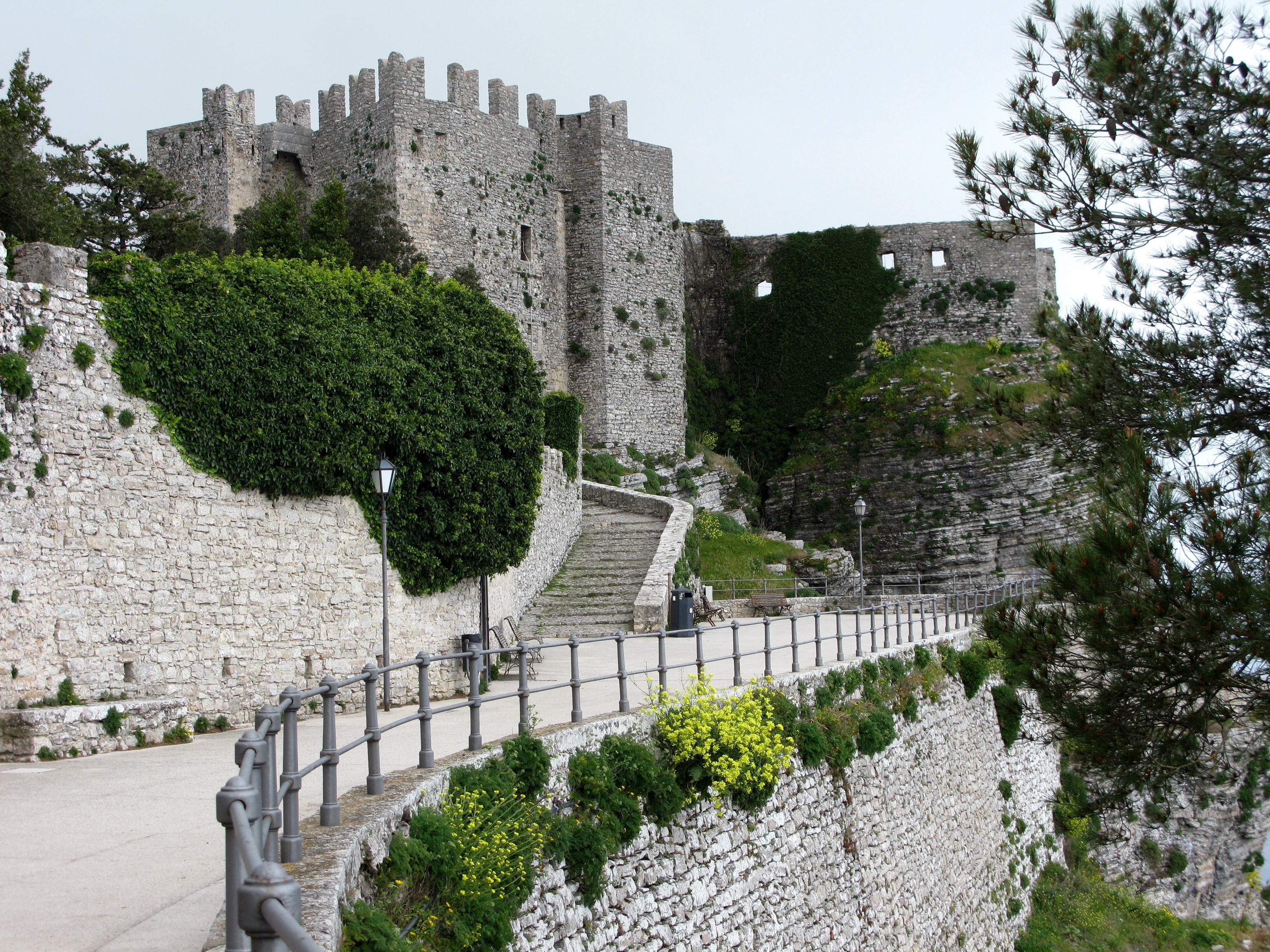 Castle walls and pathway on a hill HD Wallpaper