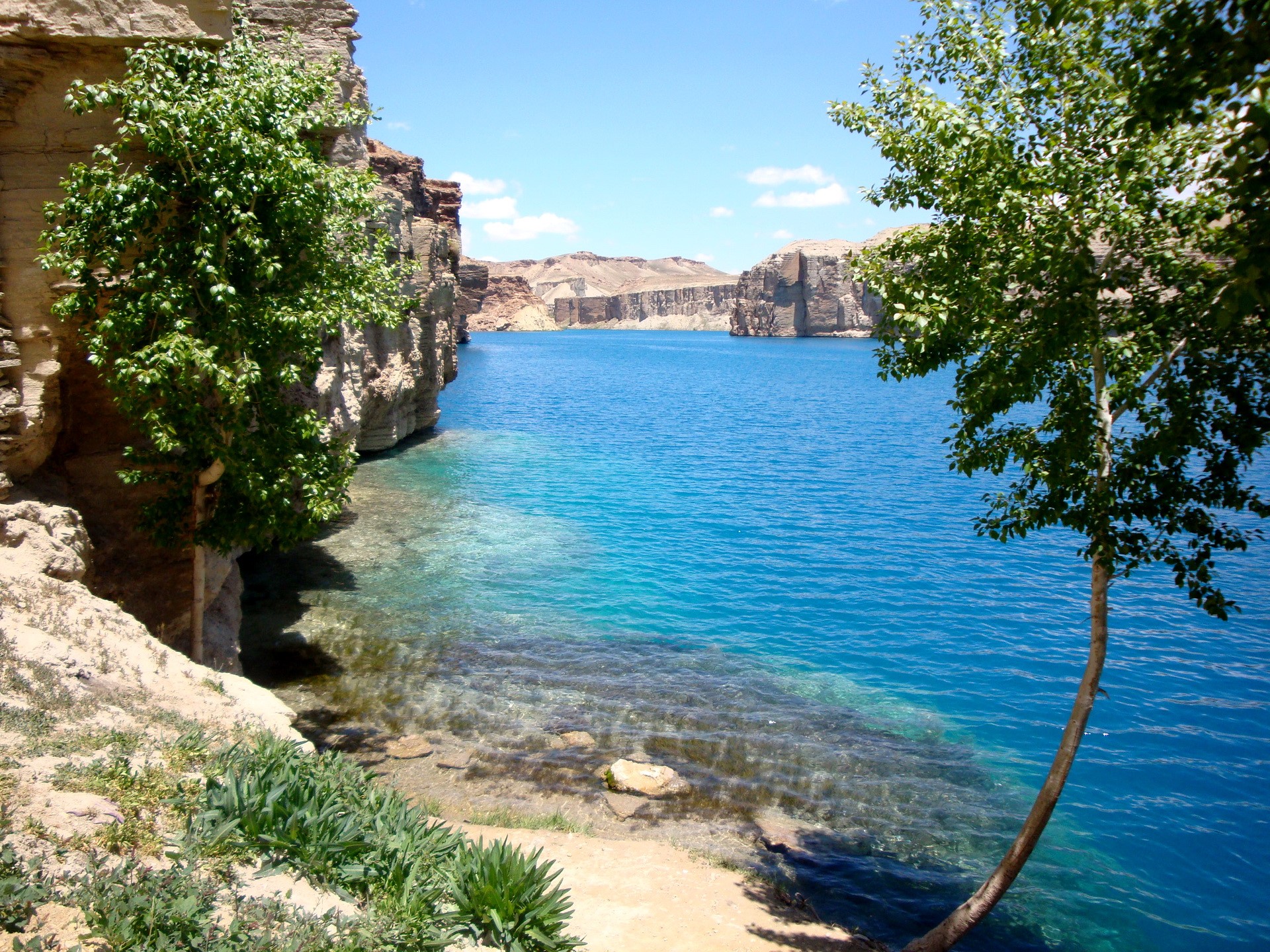 Blue lake between rocky cliffs with trees HD Wallpaper