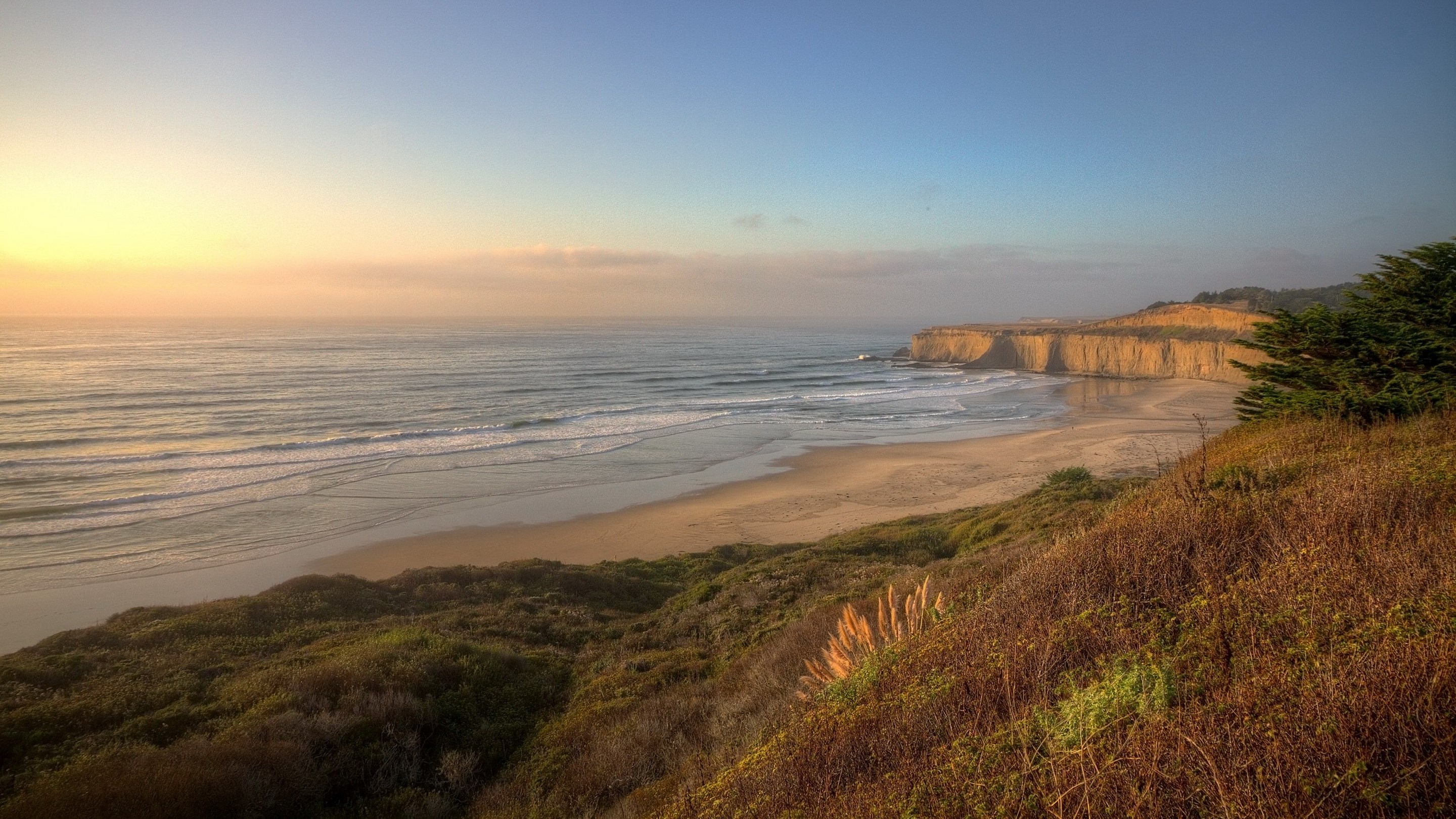Coastal cliffs and ocean at sunset HD Wallpaper