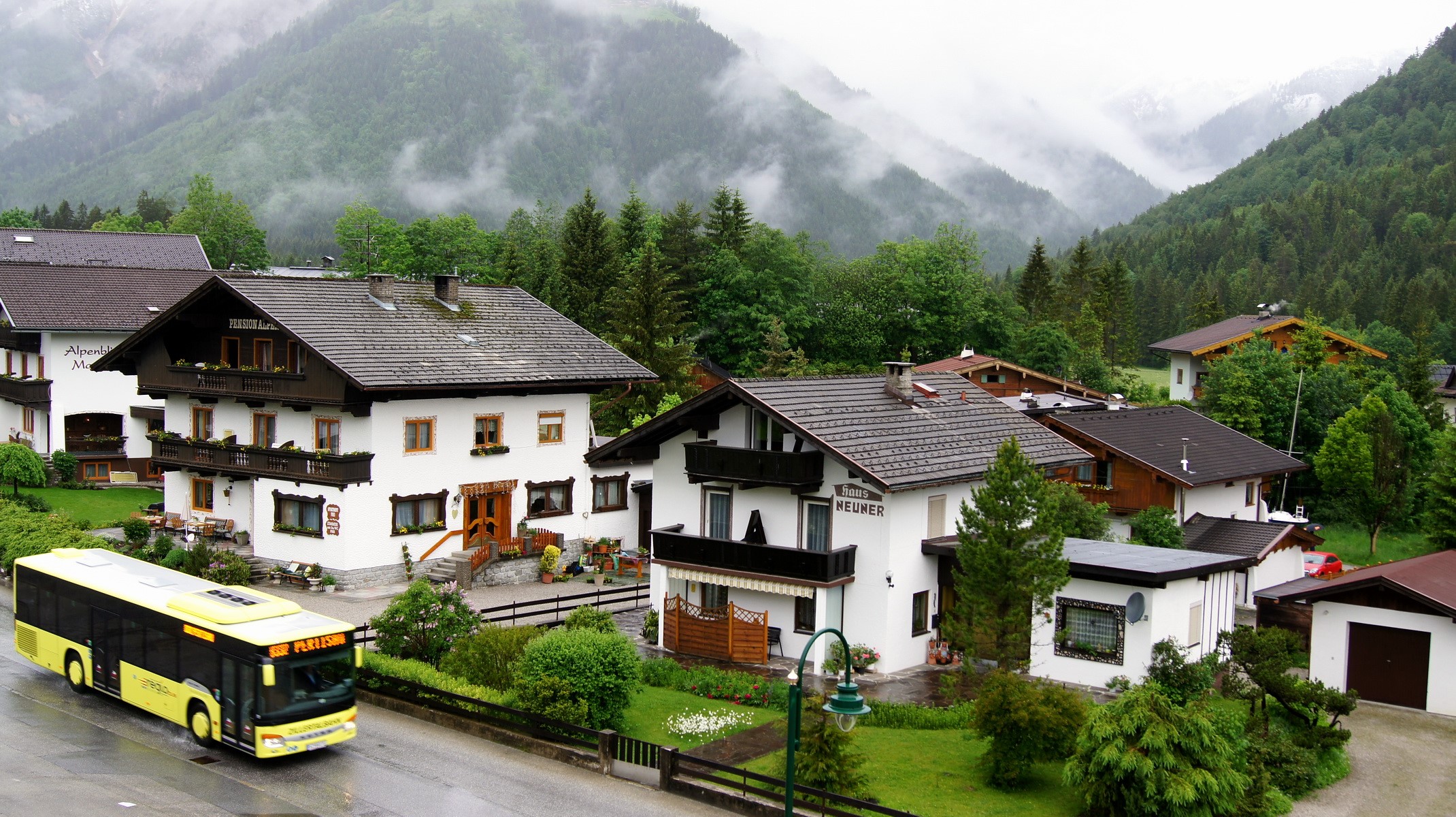 Yellow bus in a village in Austria HD Wallpaper