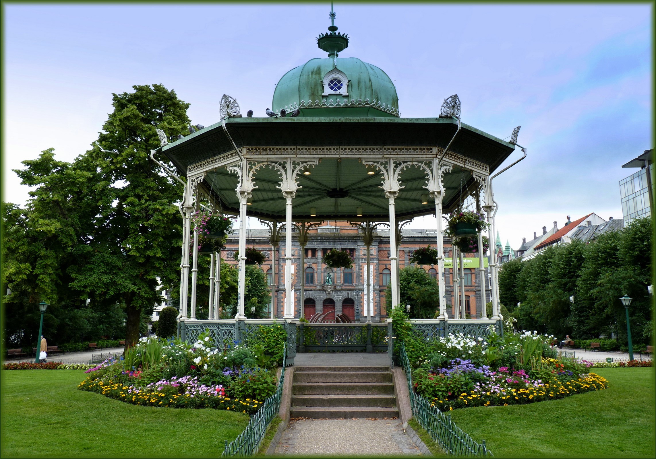 Gazebo in a park with a building in the background HD Wallpaper