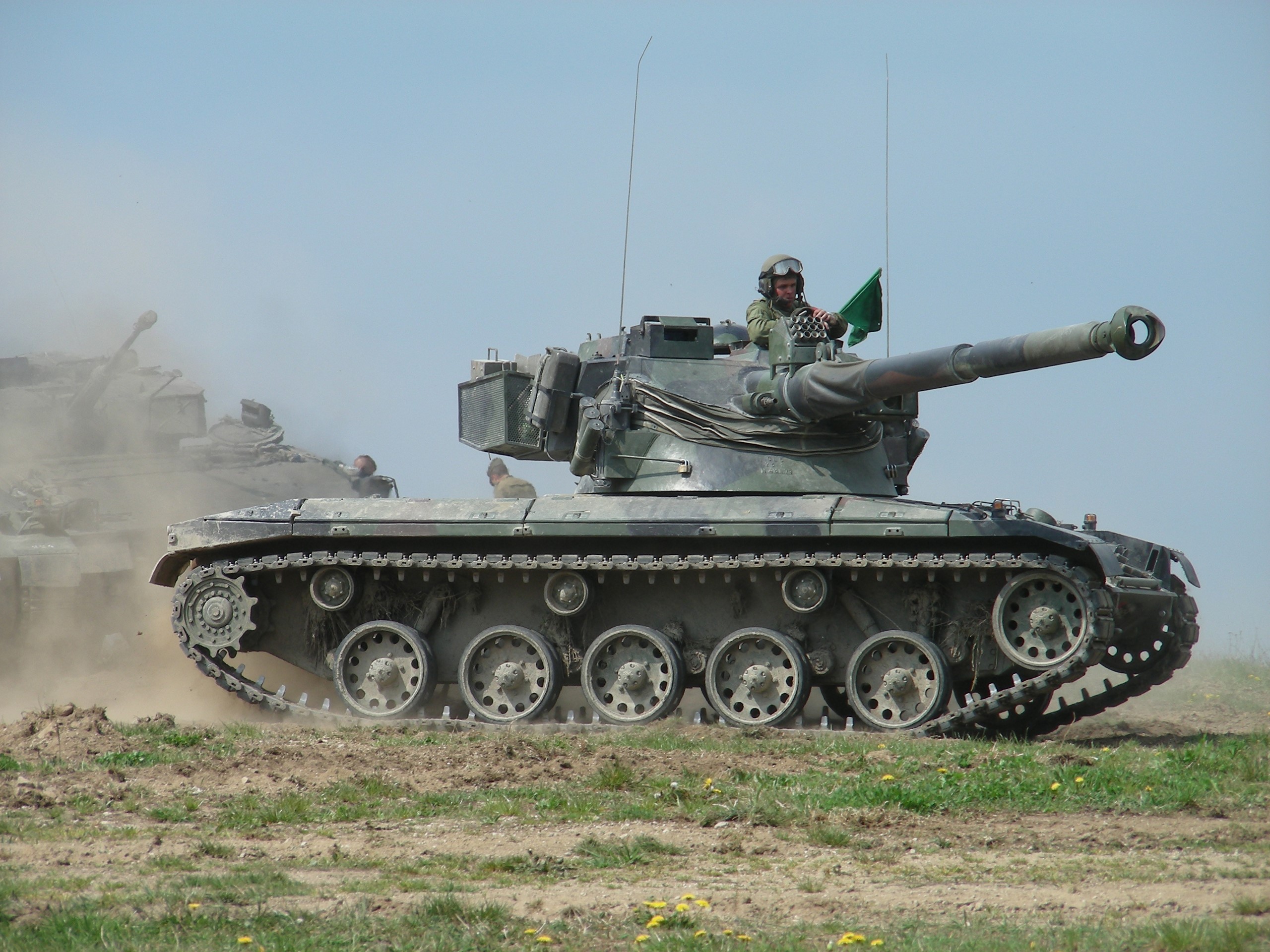 Two tanks on a dusty field with a soldier waving a flag HD Wallpaper