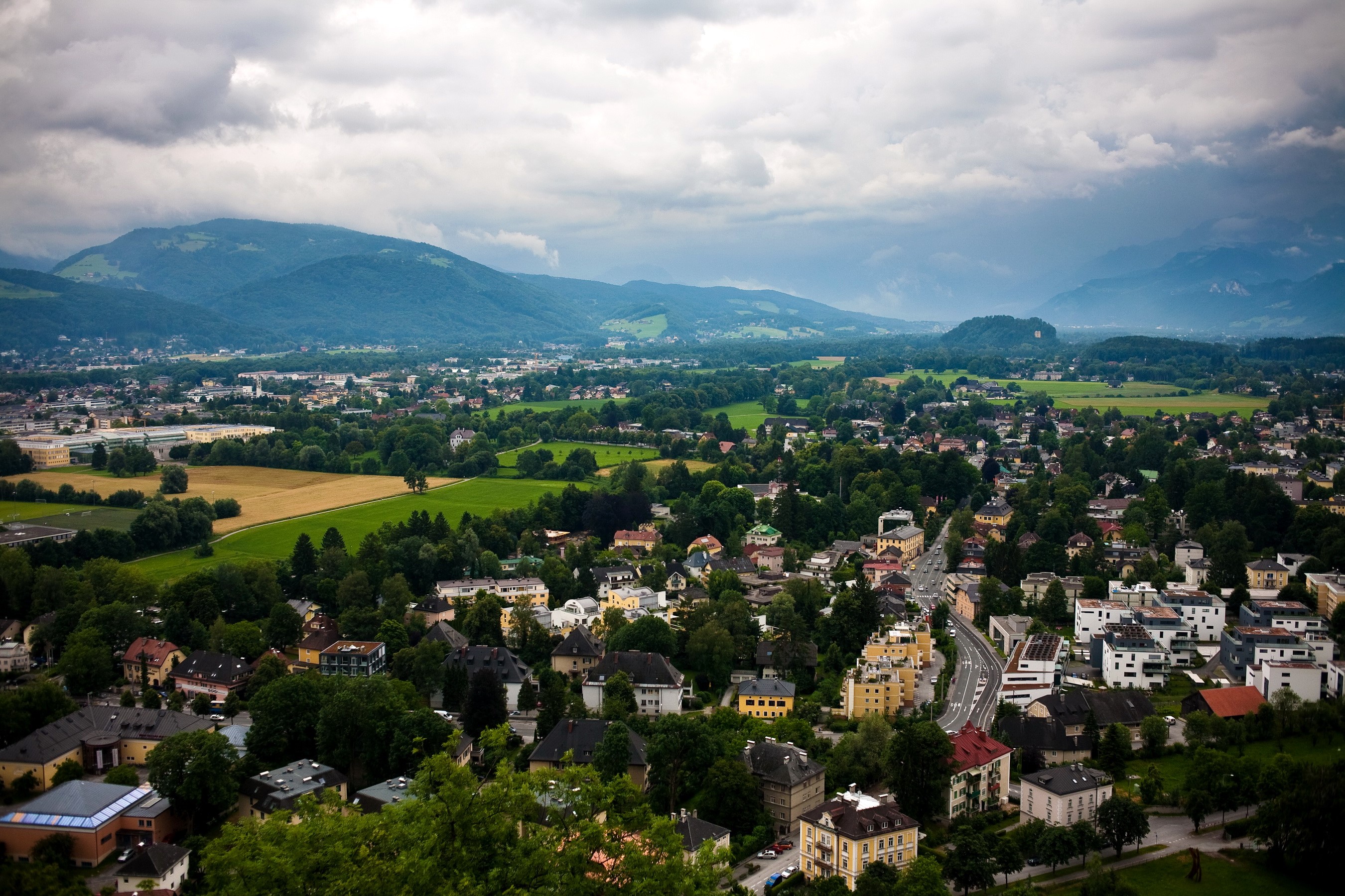 Aerial view of Salzburg, Austria with mountains in the background HD Wallpaper
