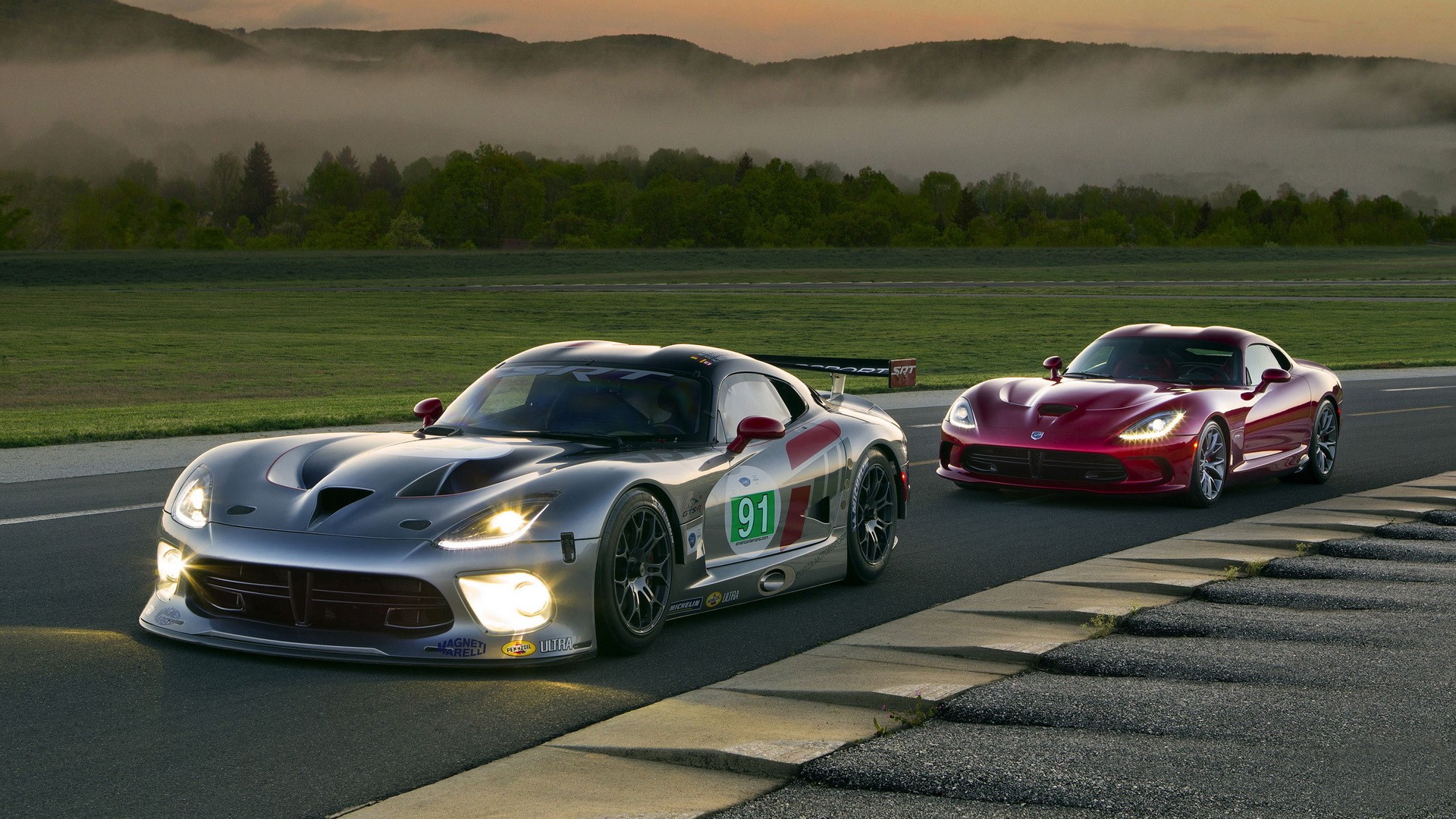 Two Dodge Viper cars on a race track HD Wallpaper