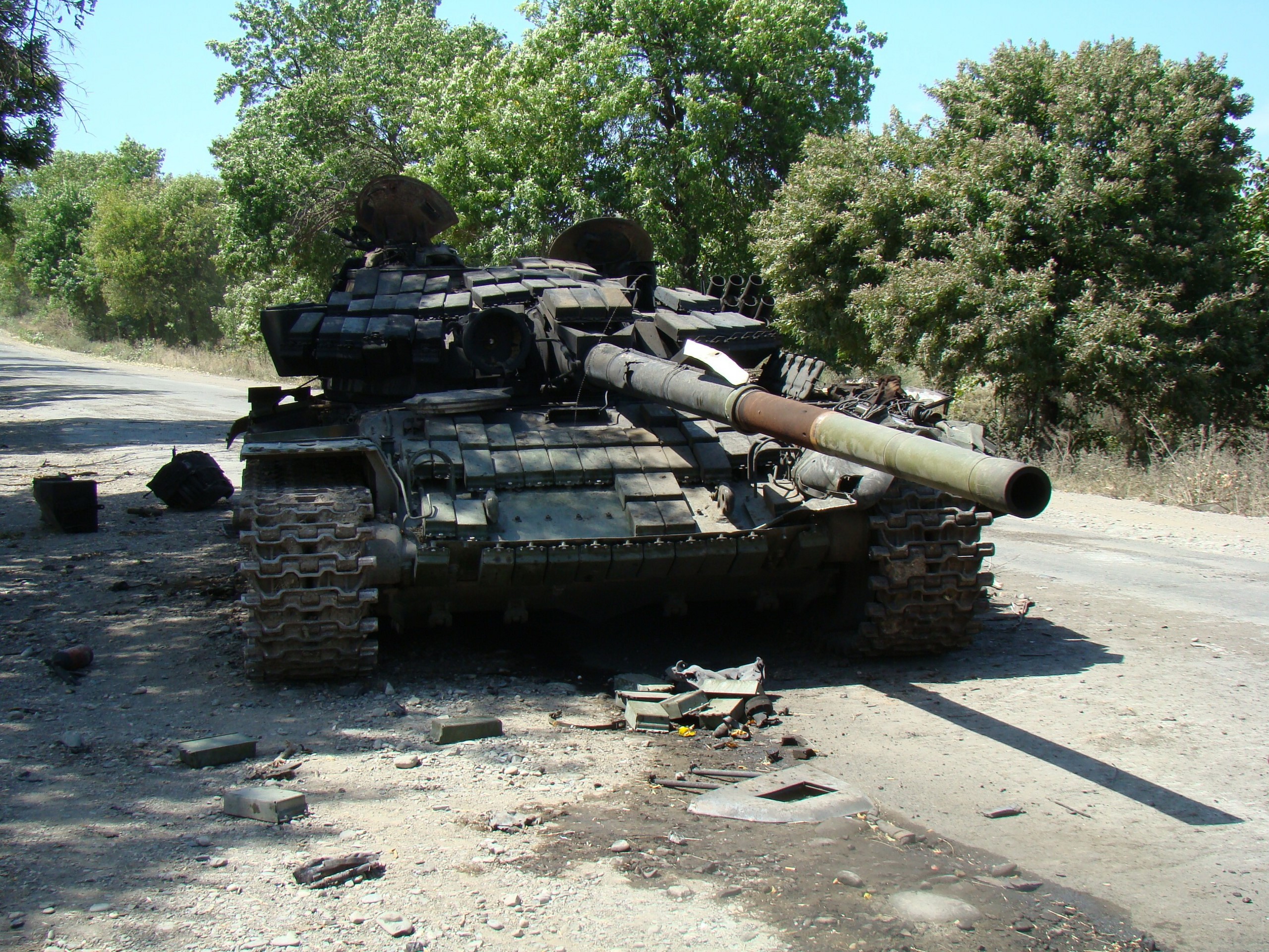 Destroyed tank on a dirt road HD Wallpaper