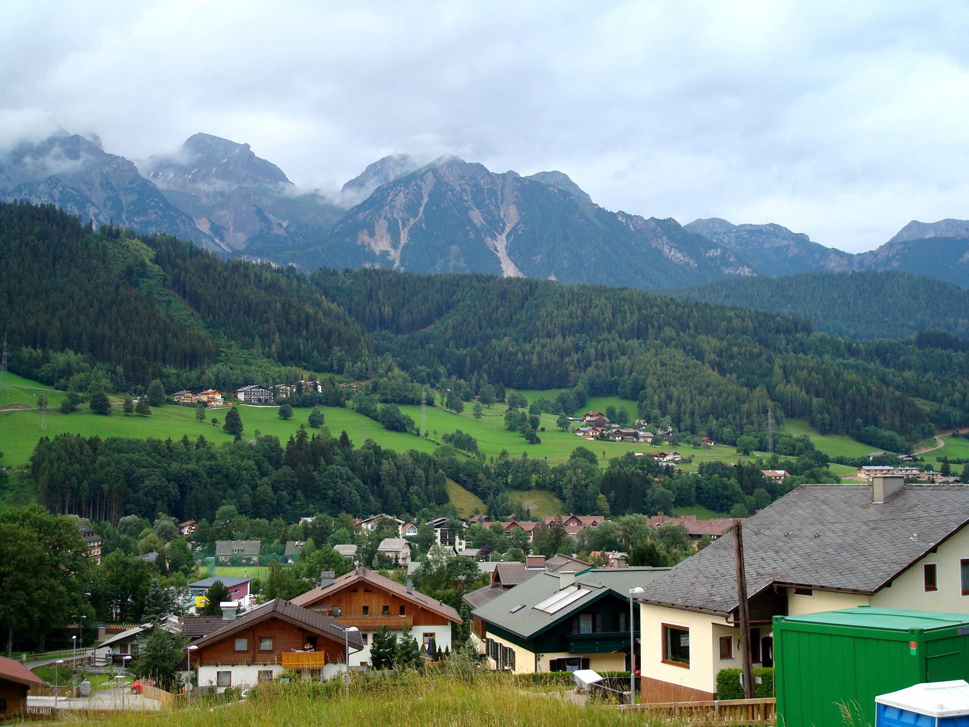 Alpine village with mountains in Austria HD Wallpaper