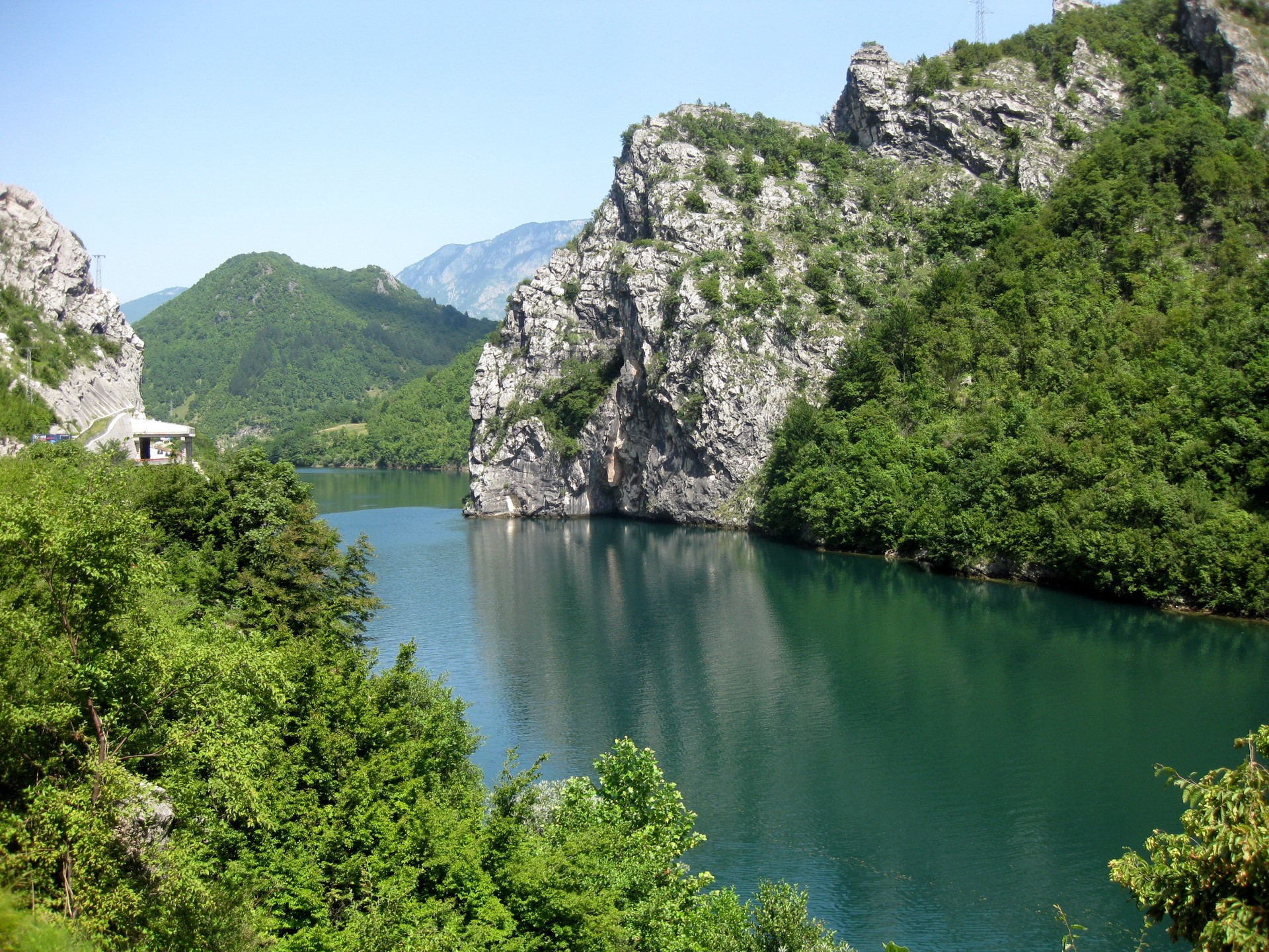 River flowing through a rocky, forested canyon HD Wallpaper
