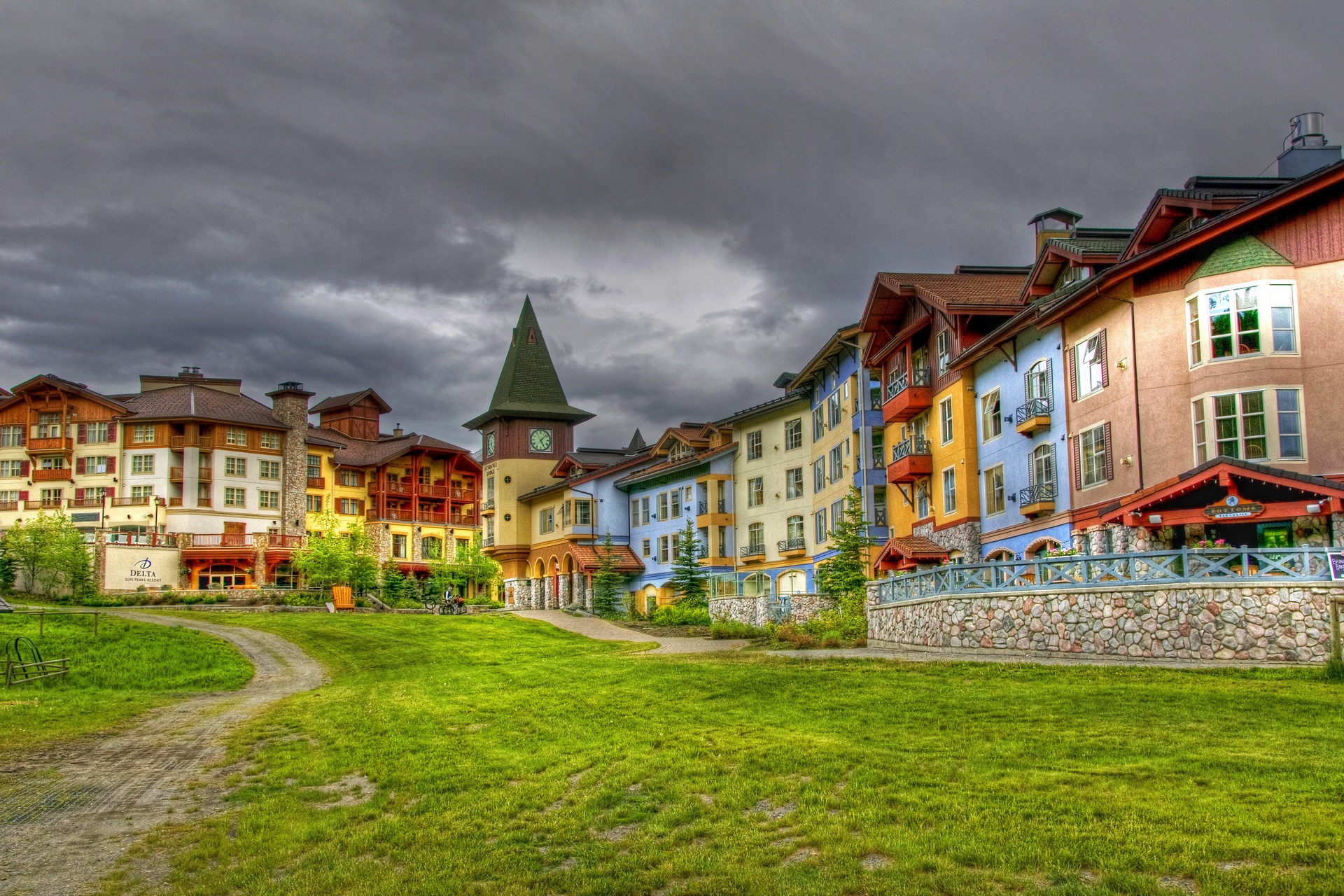 Colorful buildings and clock tower in Sun Peaks, Canada HD Wallpaper