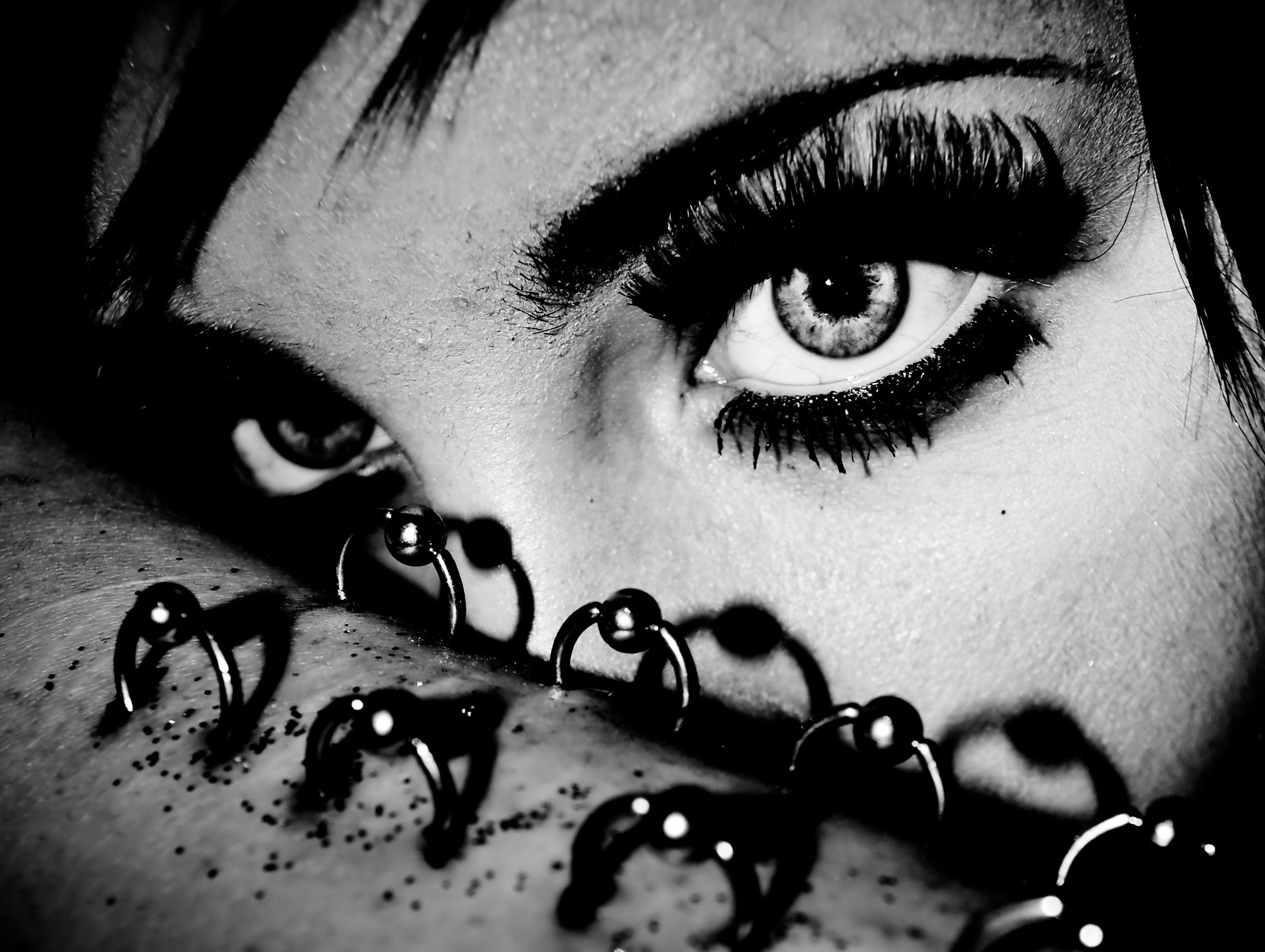 Close-up of a person's eyes and piercings HD Wallpaper