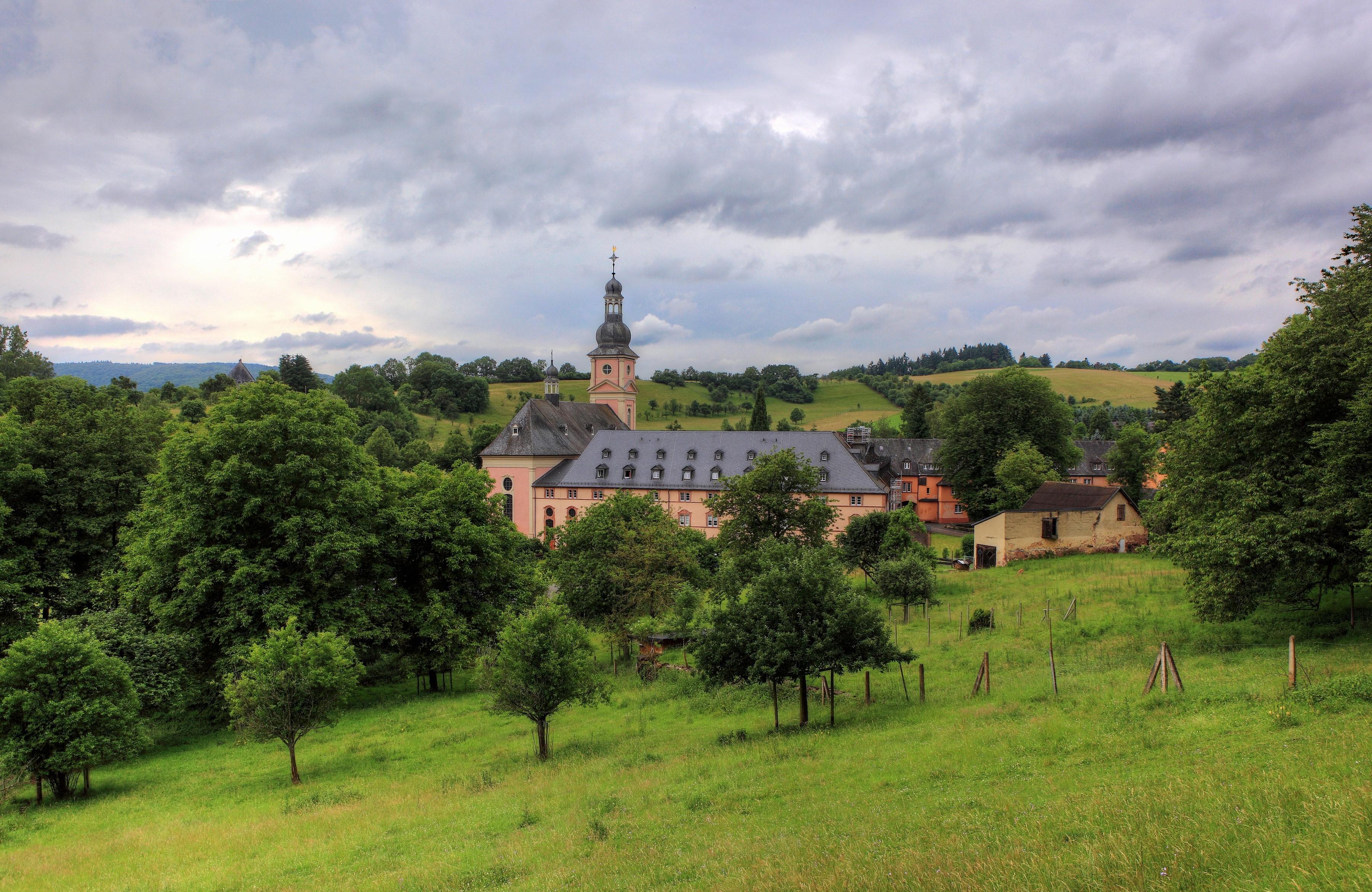 Monastery building with tower in a green landscape, Germany HD Wallpaper