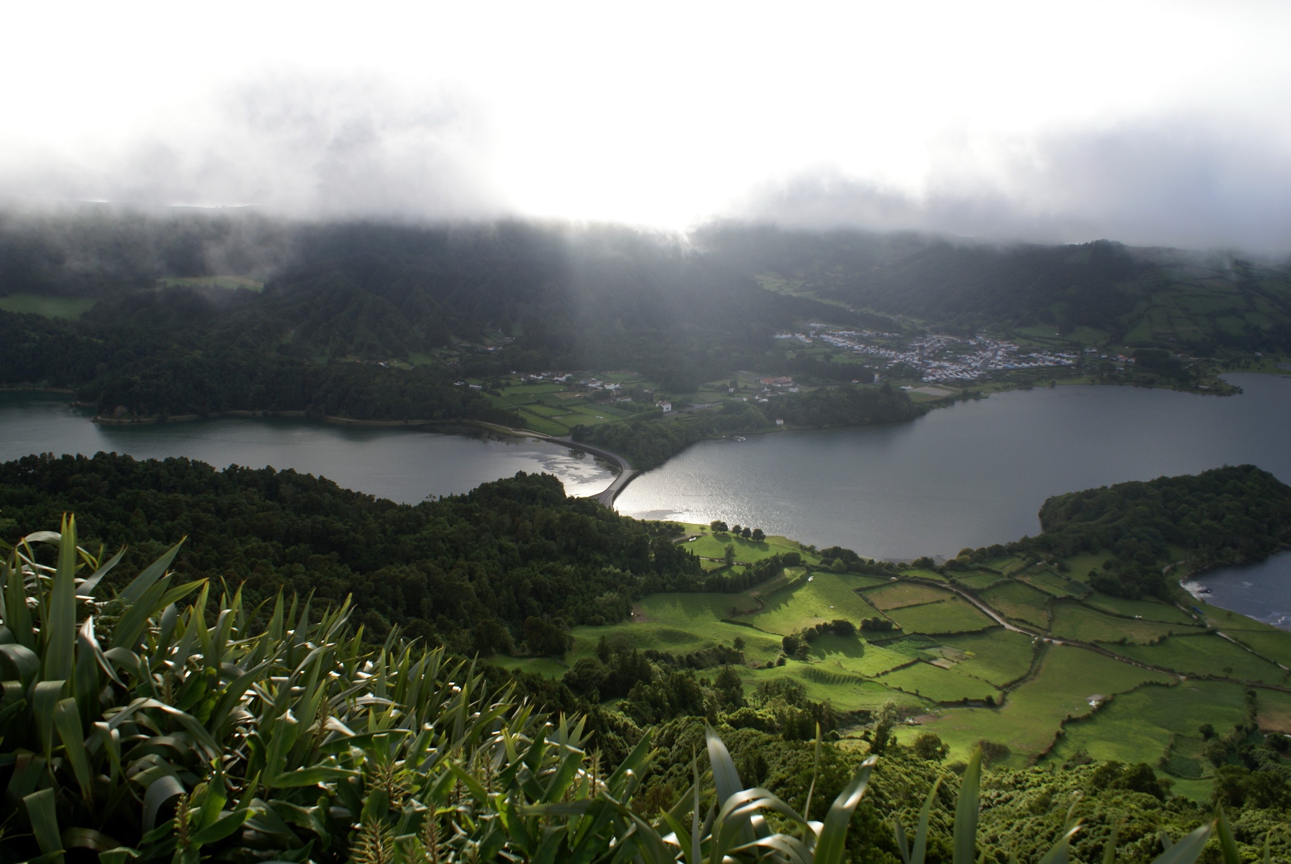 View of a lake and village from a hilltop HD Wallpaper