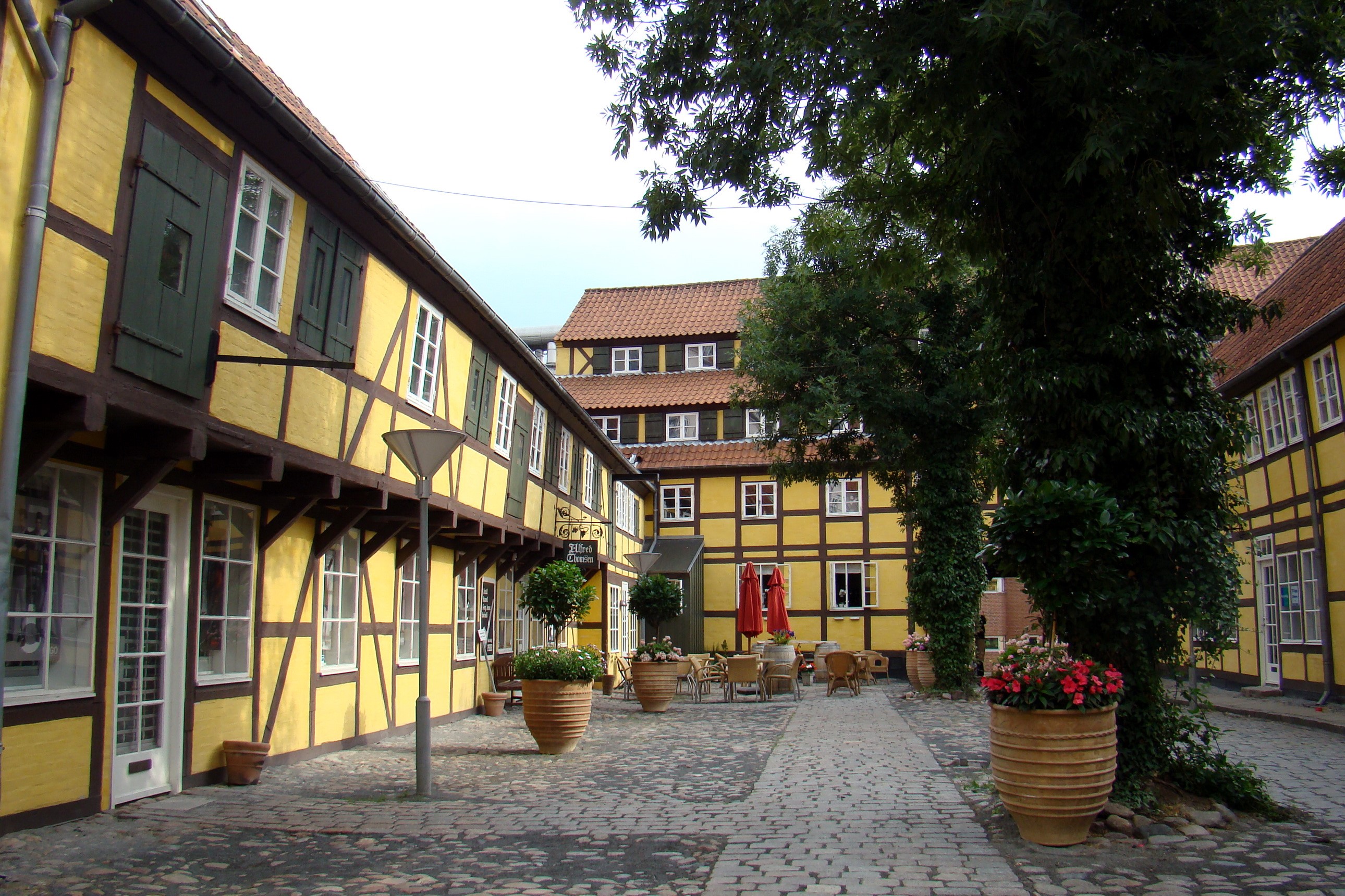 Half-timbered yellow buildings in Denmark courtyard HD Wallpaper