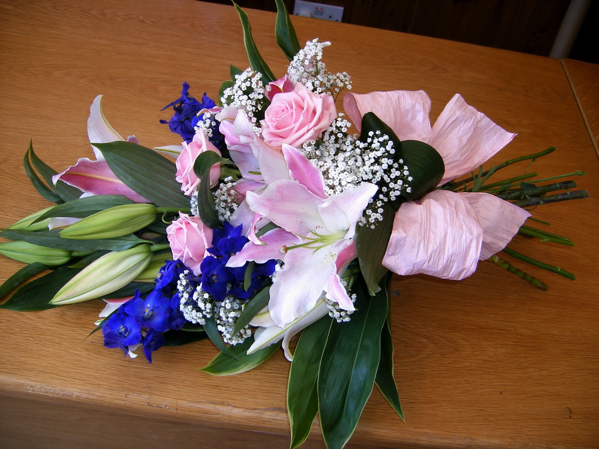 Bouquet of pink roses and lilies with blue delphiniums HD Wallpaper