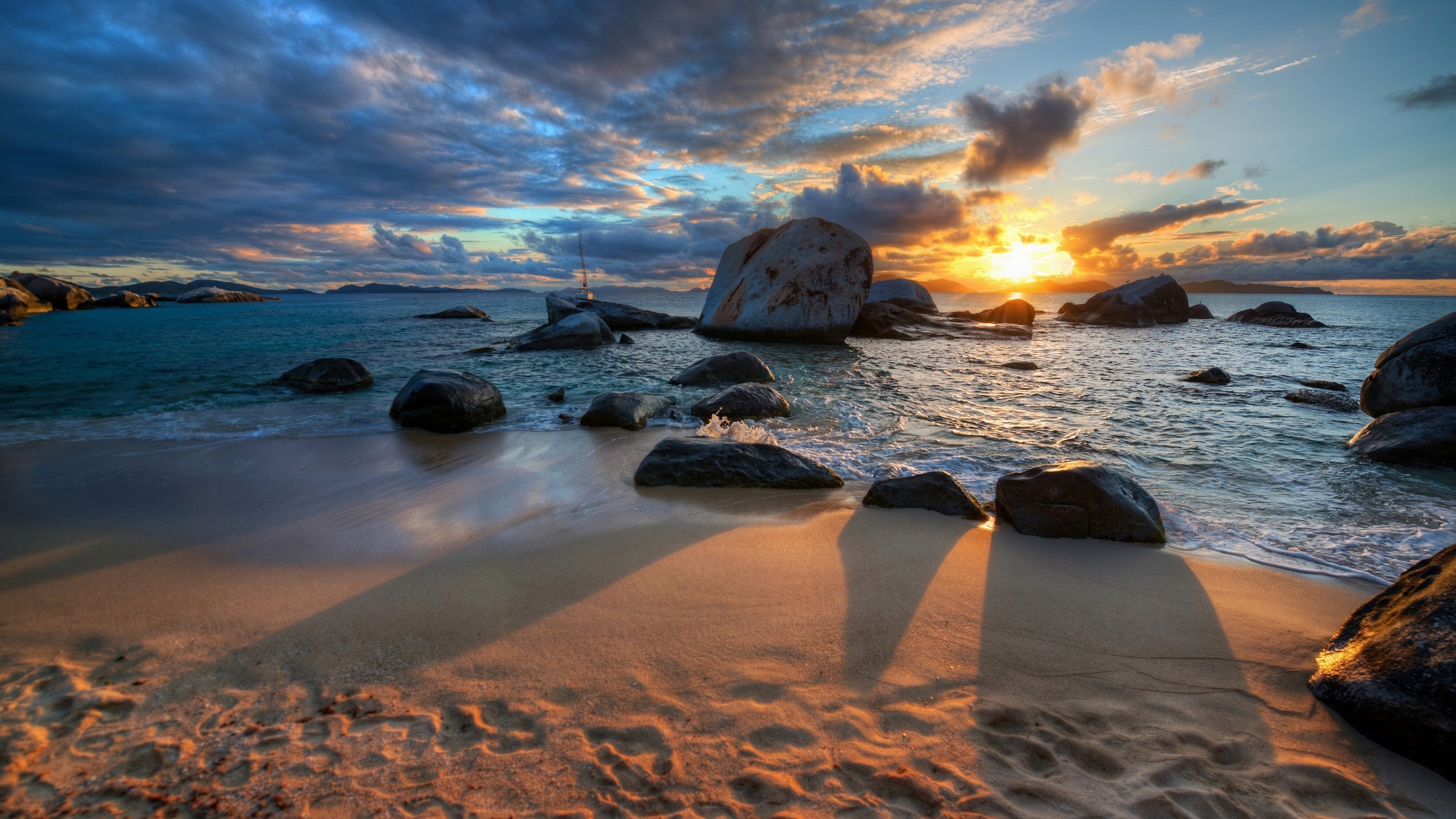 Sunset over rocky beach with ocean waves HD Wallpaper
