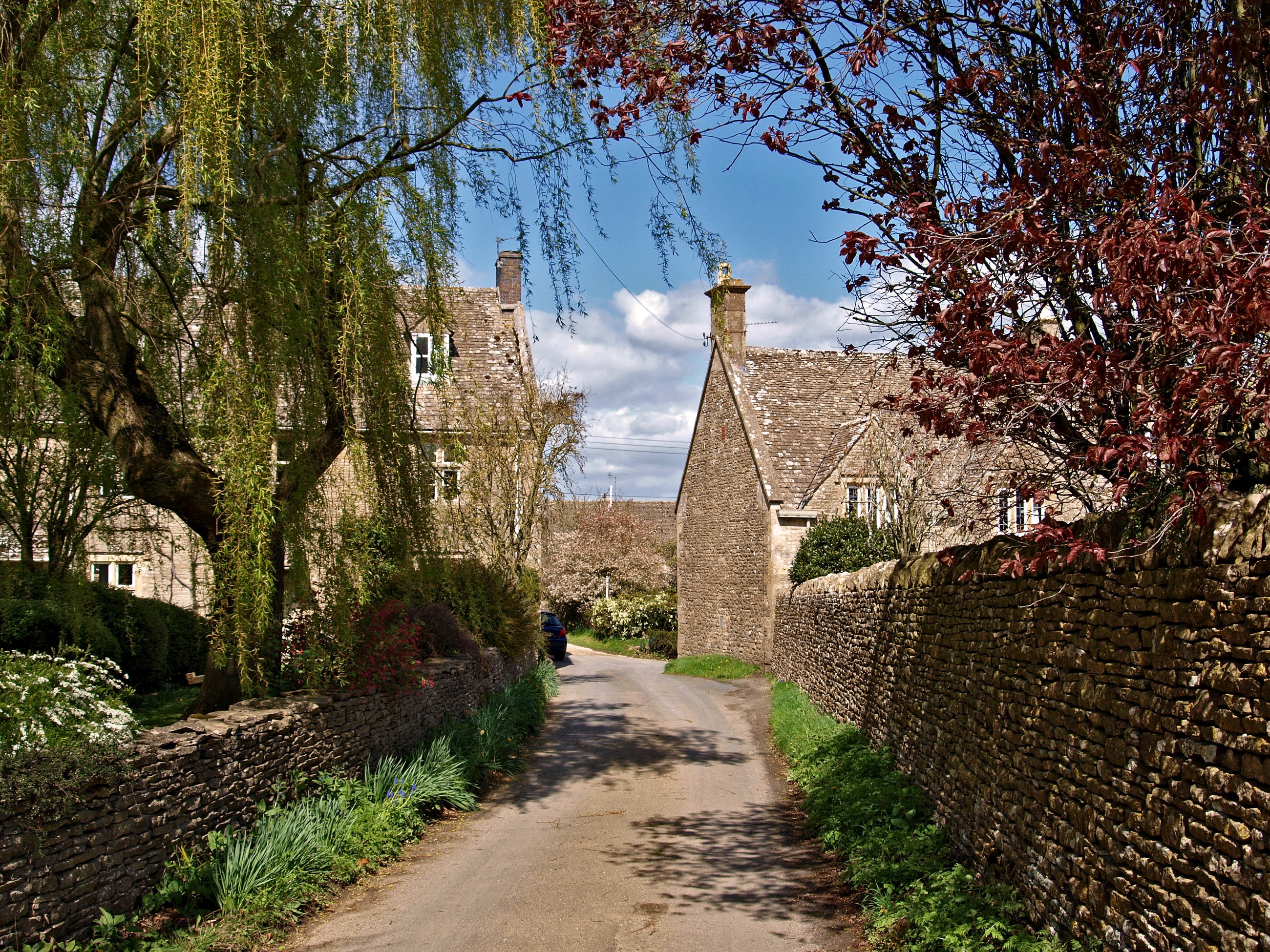 Village road with stone walls and houses in the UK HD Wallpaper
