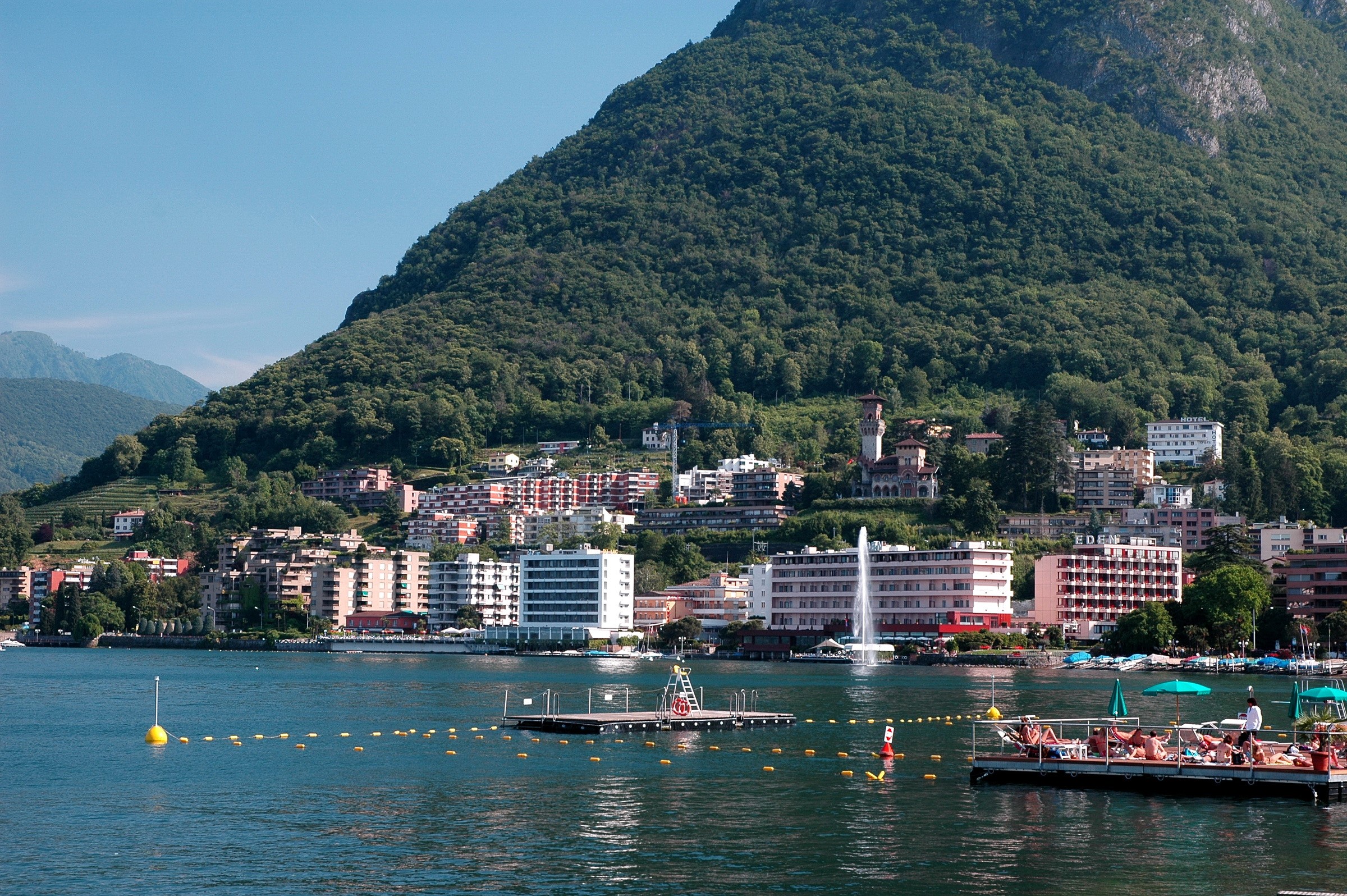 Buildings on a mountainside overlooking a lake in Switzerland HD Wallpaper