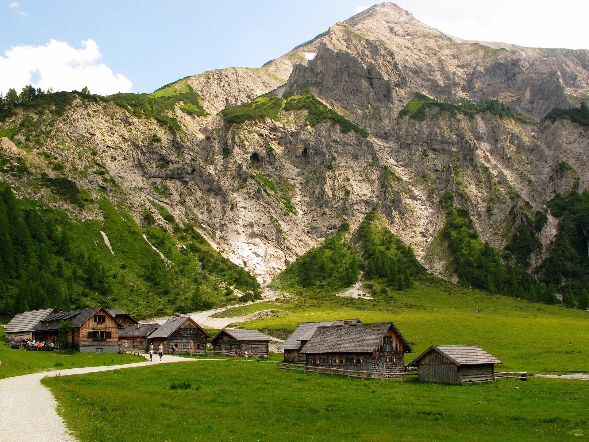 Wooden houses in a mountain valley HD Wallpaper