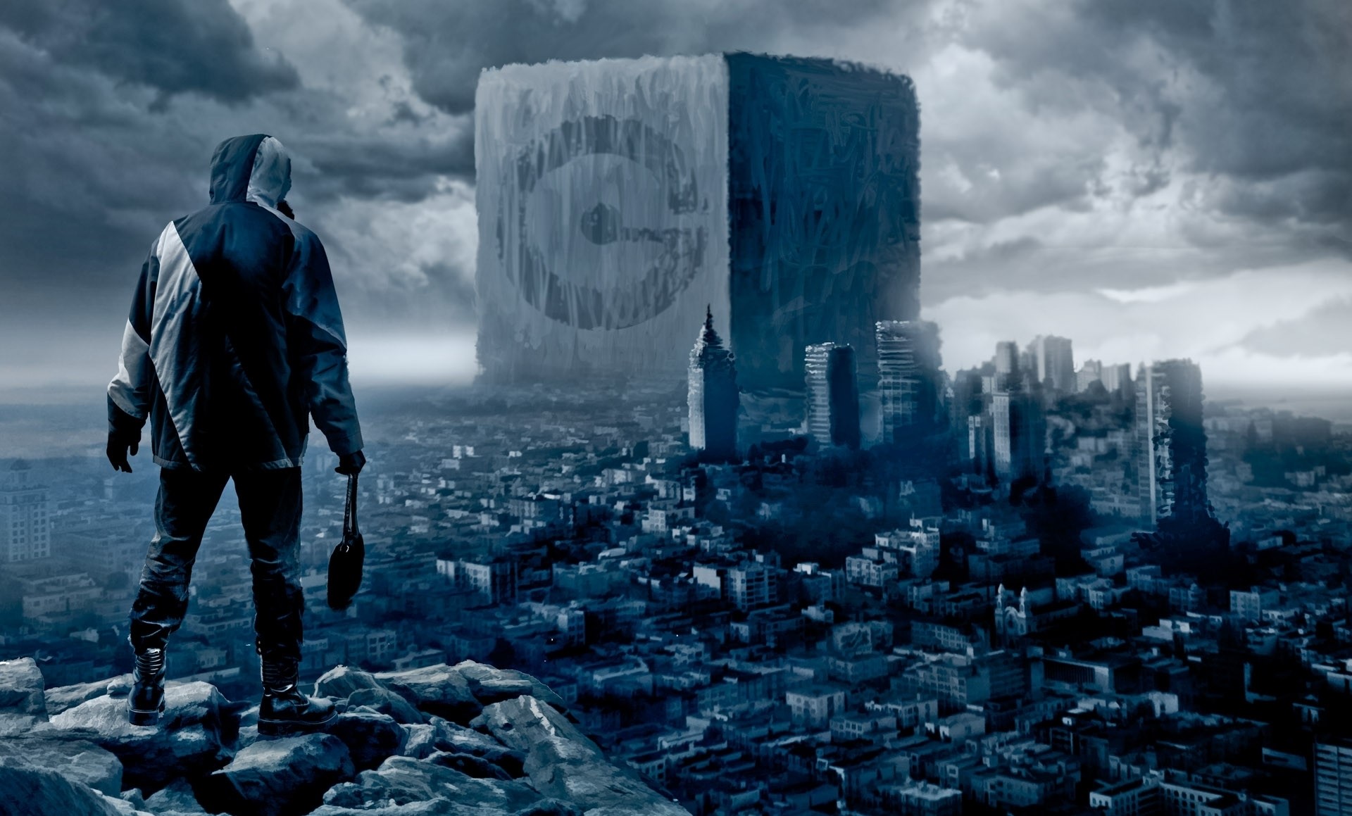 Man standing on rocks overlooking a destroyed city and a giant cube HD Wallpaper