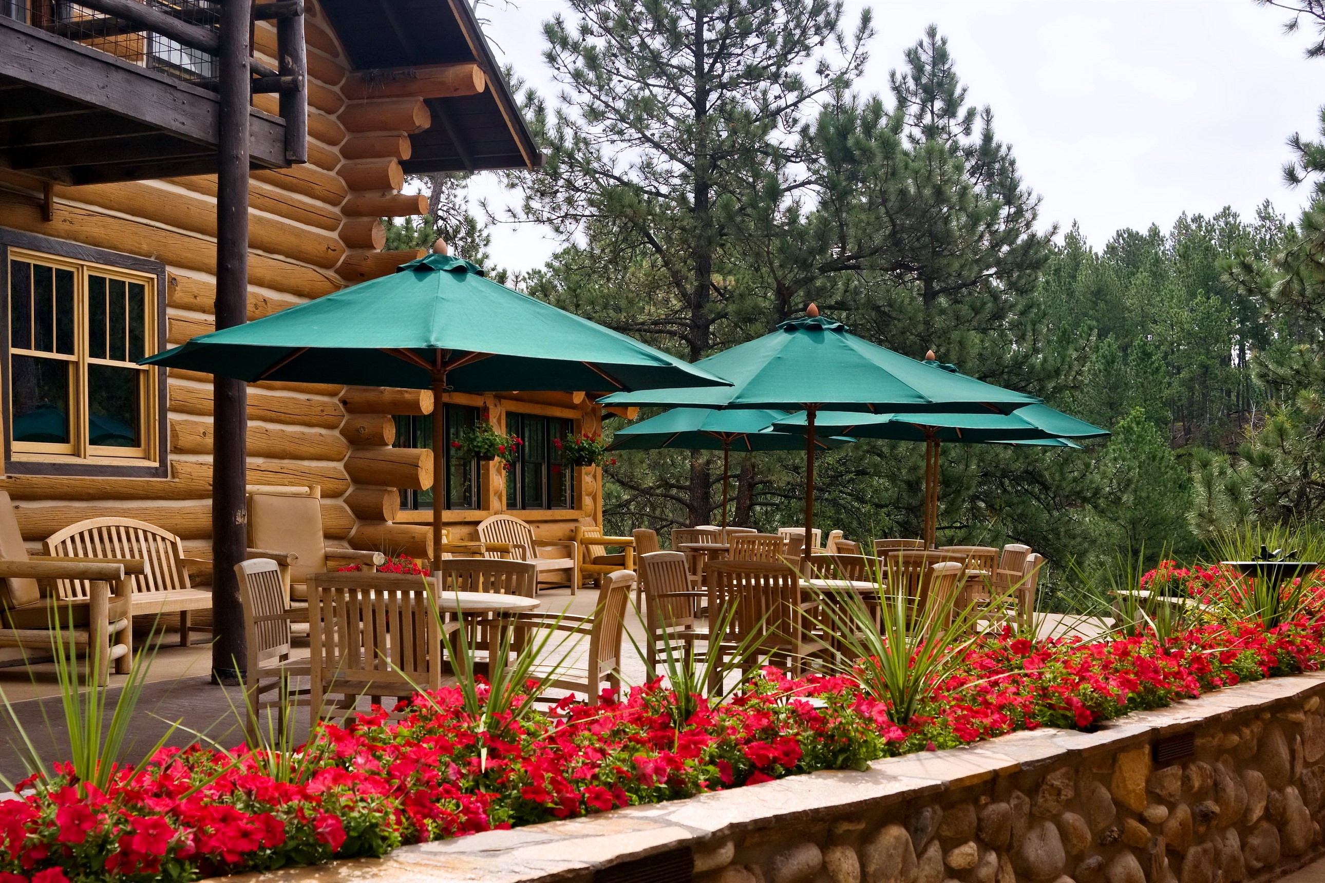 Log Cabin with Outdoor Seating and Flowers HD Wallpaper
