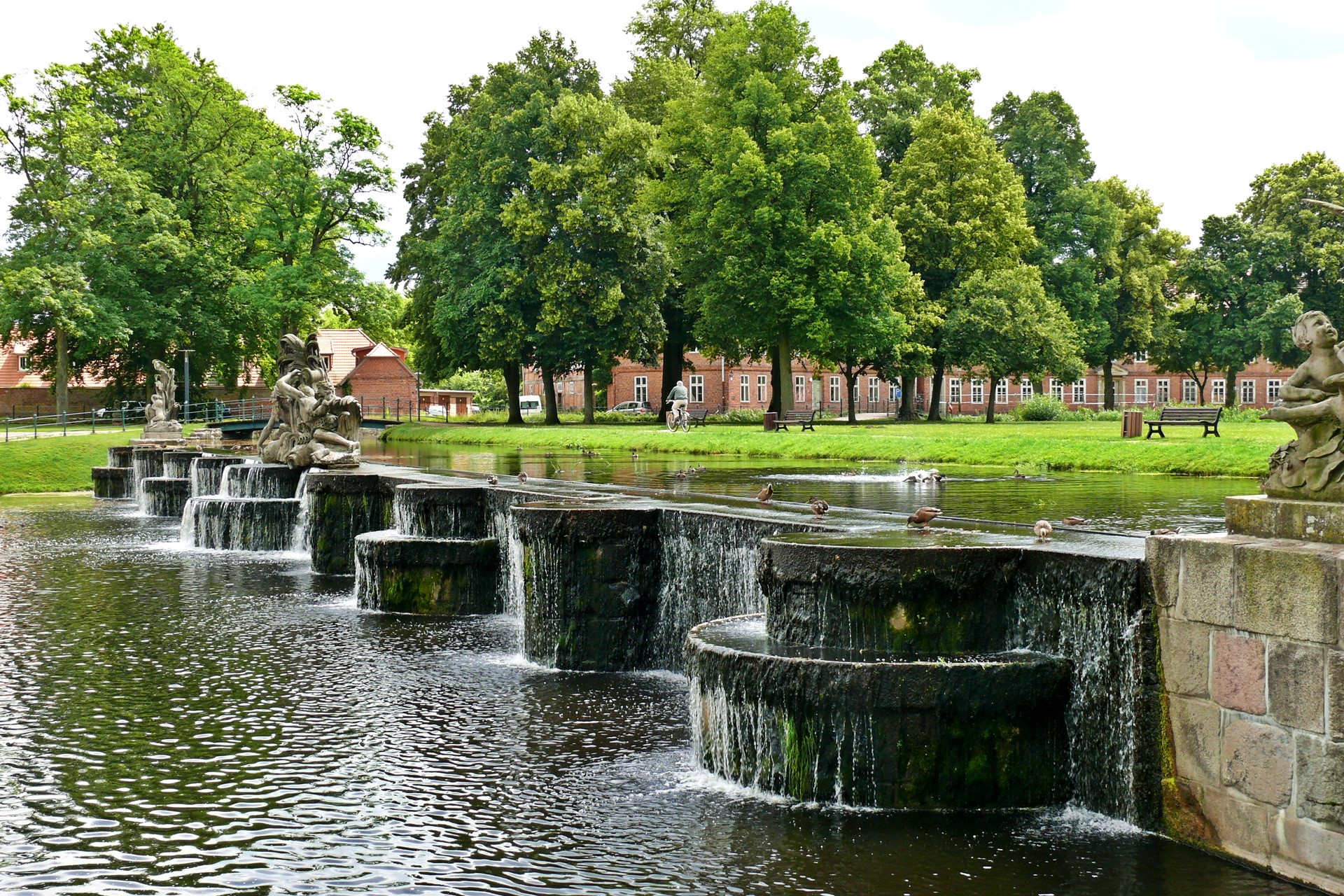 Park with cascading fountains and sculptures HD Wallpaper