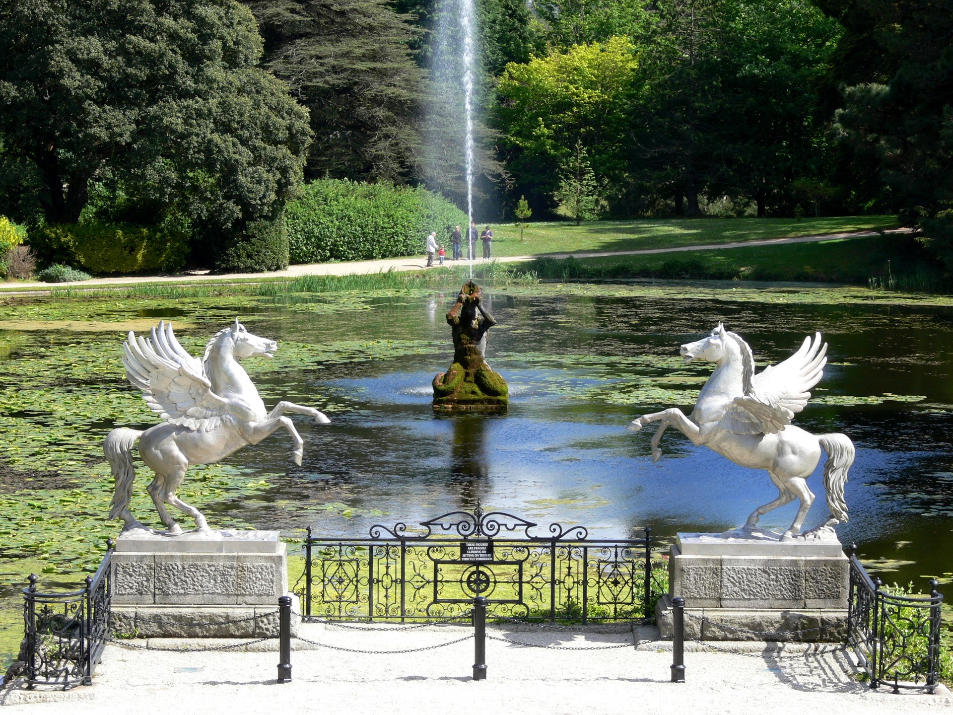 Pegasus statues in a garden pond with fountain HD Wallpaper
