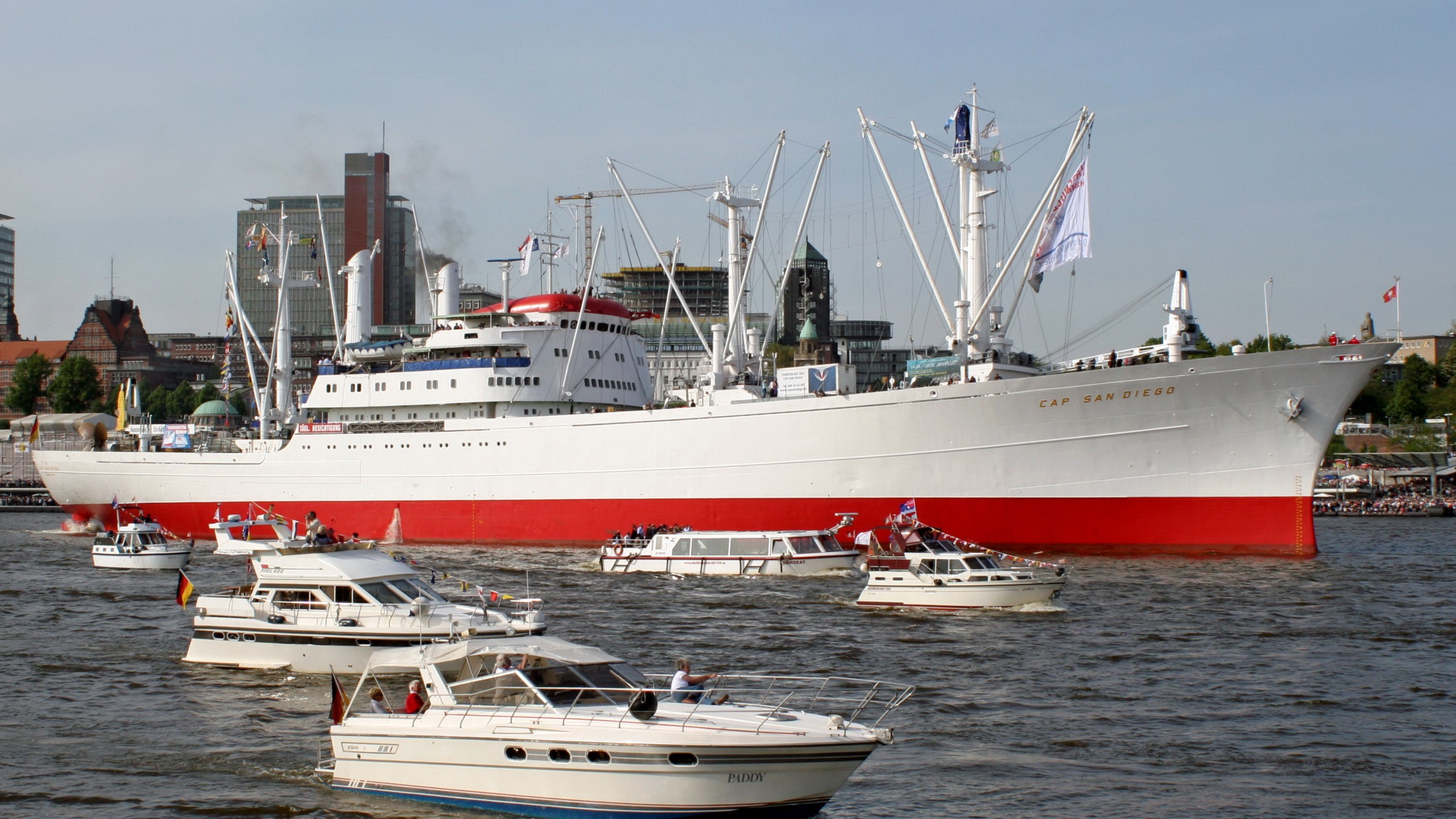Cap San Diego ship with smaller boats in harbor HD Wallpaper