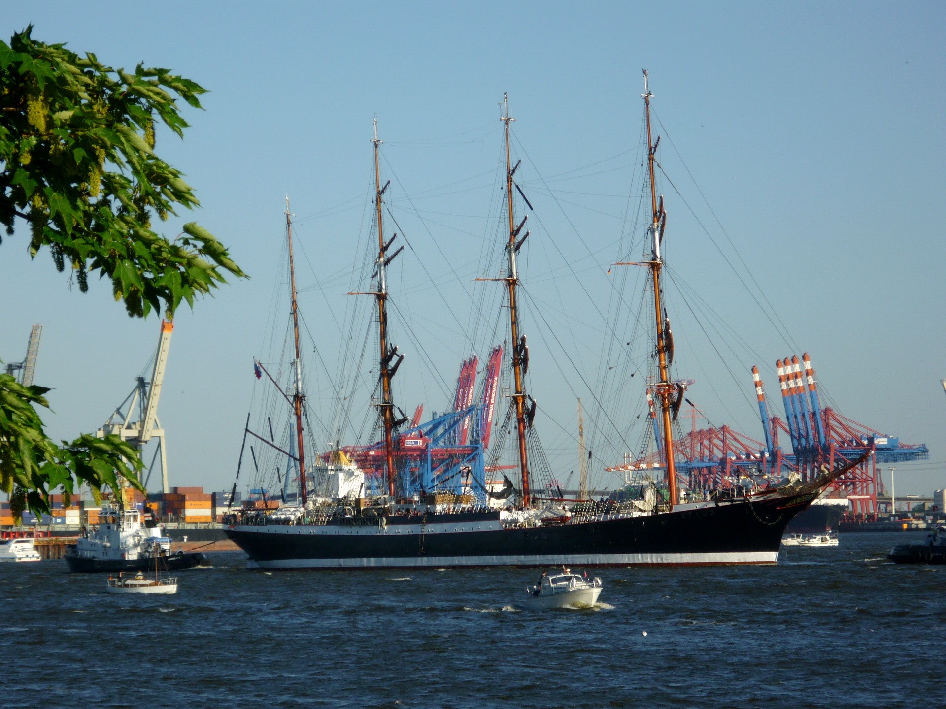 Tall Ship Sailing in a Harbor with Cranes HD Wallpaper