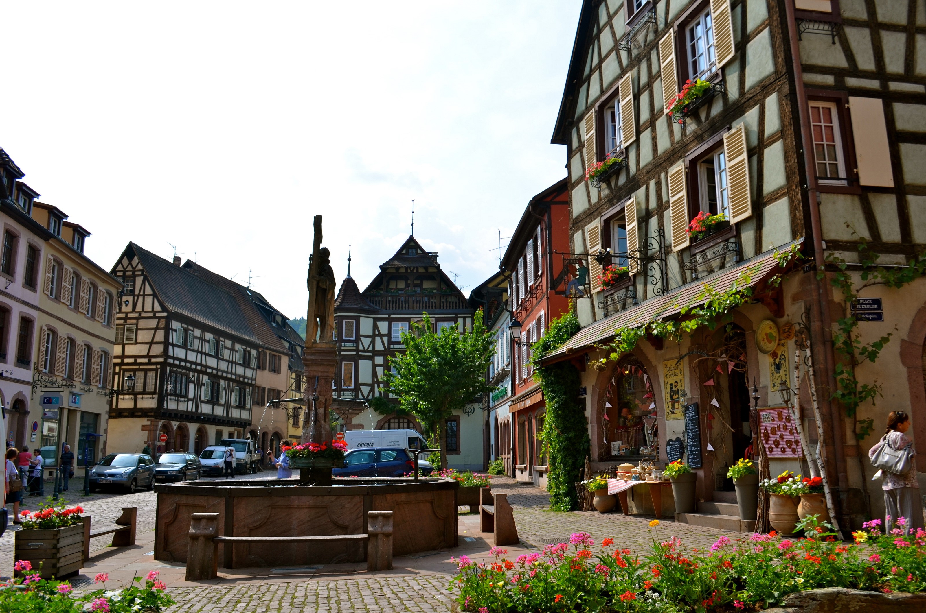 Kaysersberg town square with fountain and half-timbered buildings HD Wallpaper