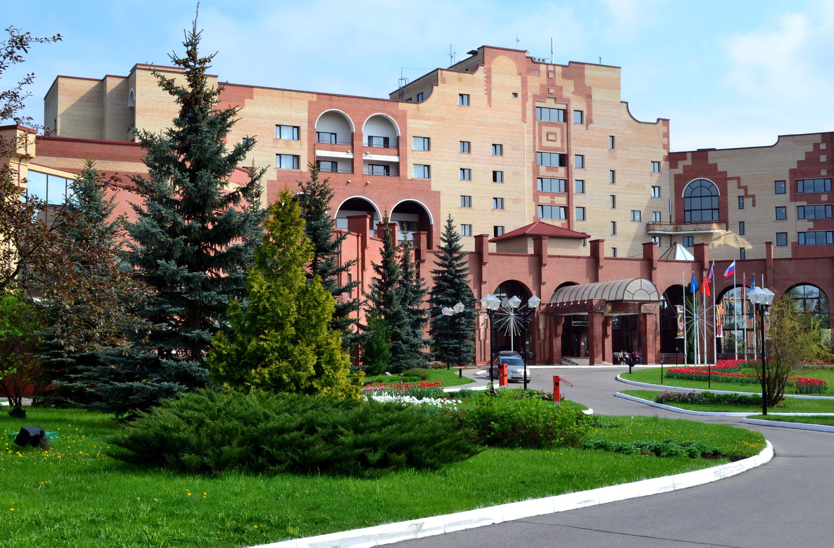 Hotel building with trees and flowers in Russia HD Wallpaper