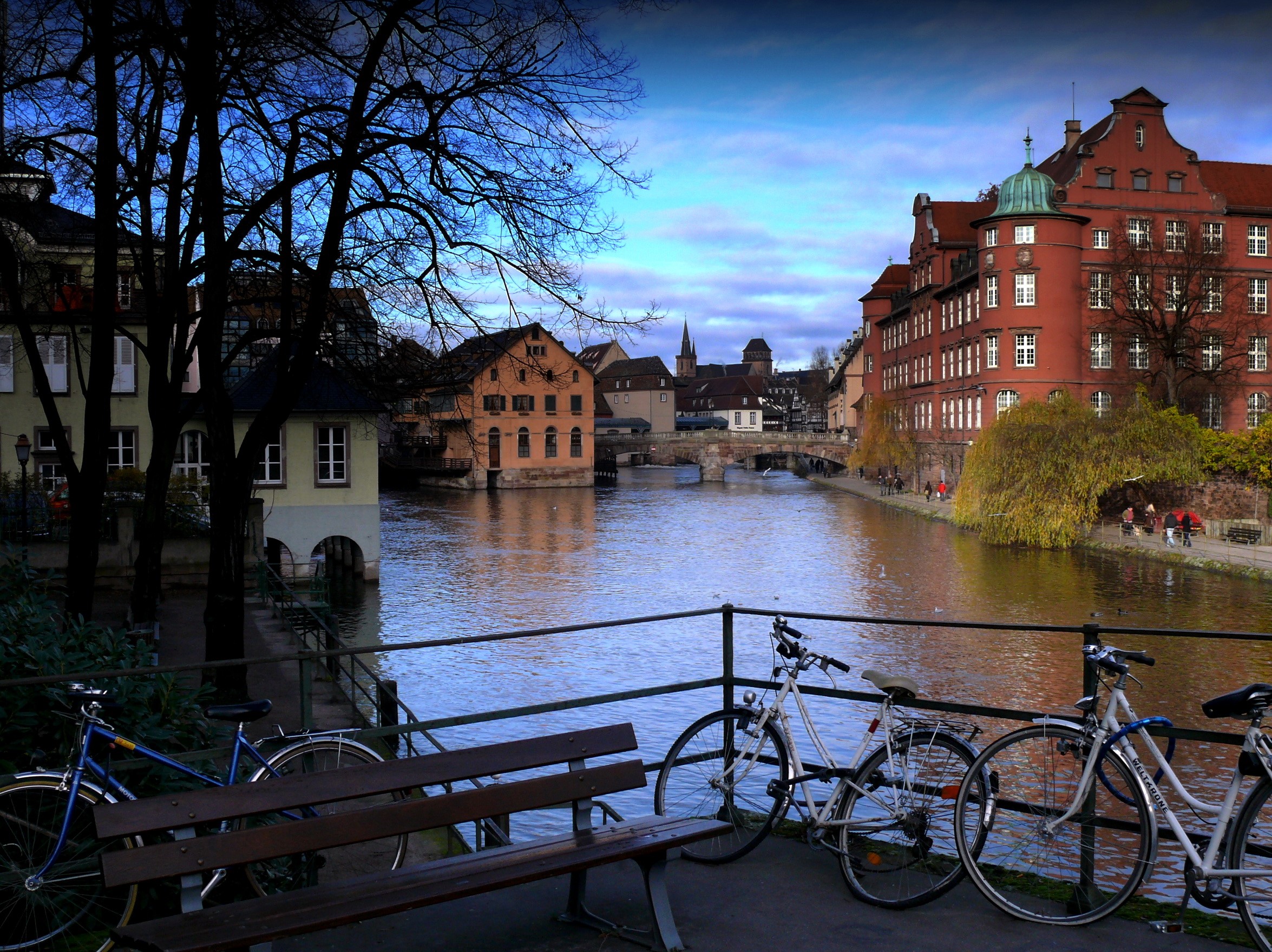 Riverfront buildings and bicycles in Alsace, France HD Wallpaper