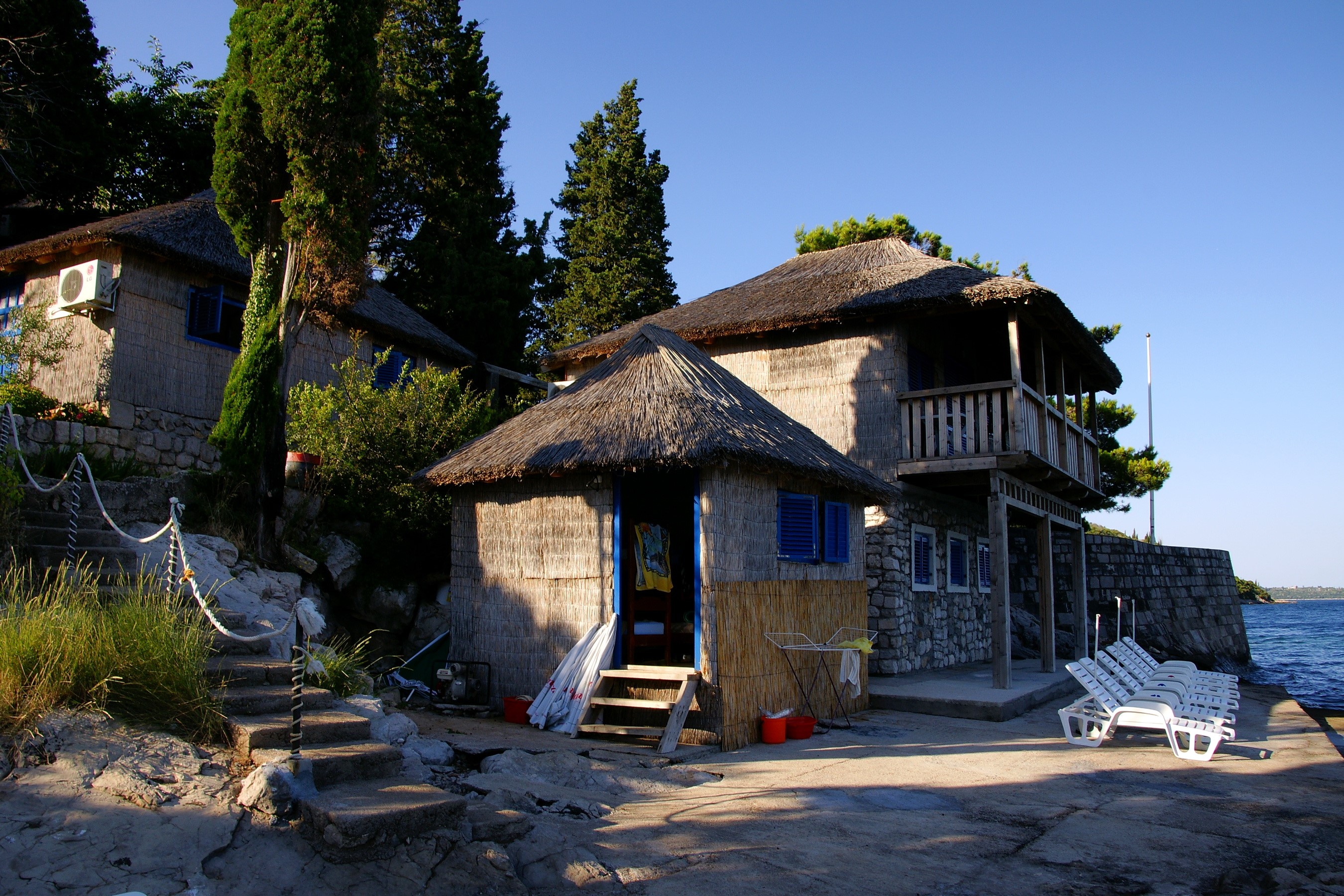 Thatched roof bungalows by the sea in Herceg Novi, Montenegro HD Wallpaper