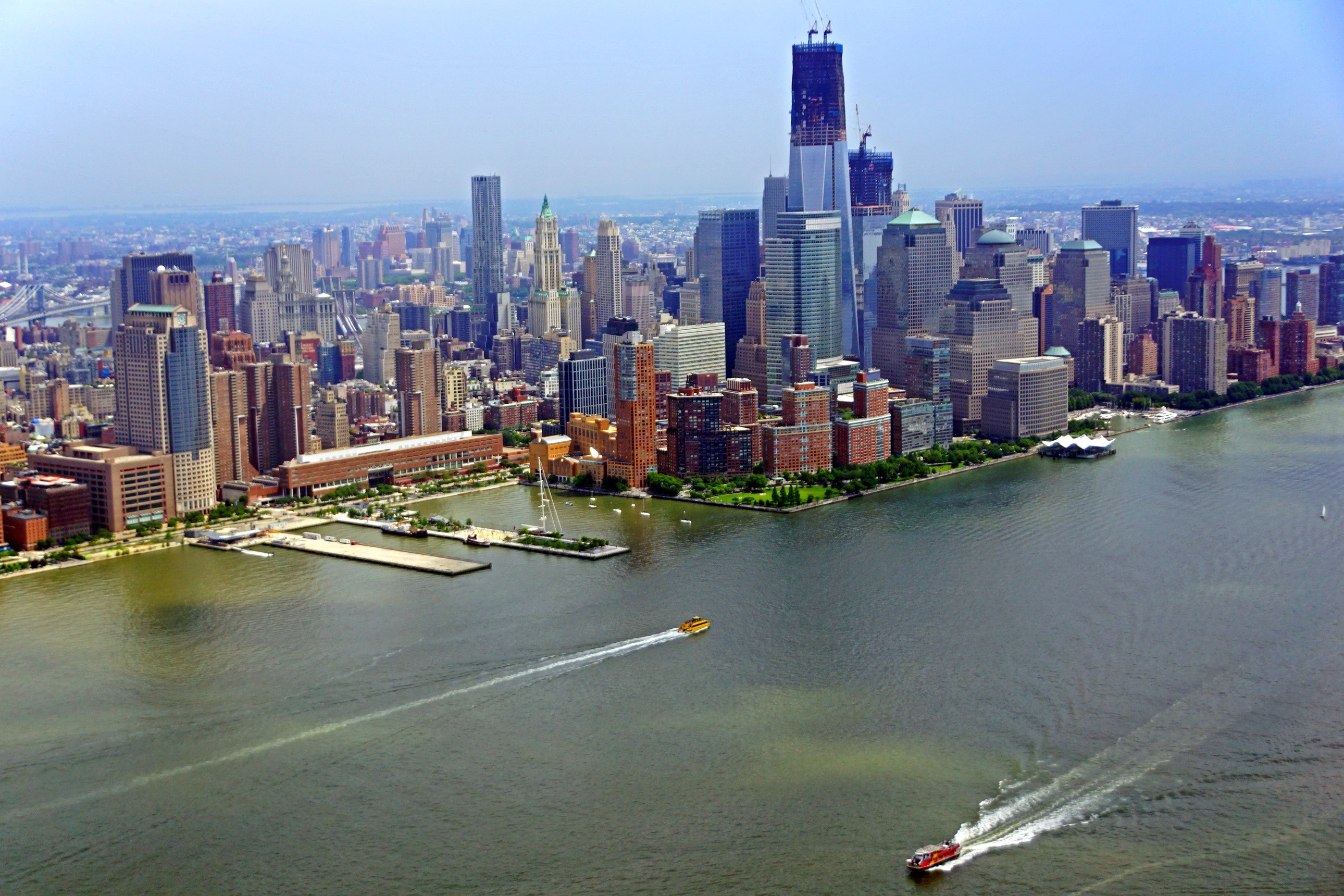 New York City skyline with boats on the water HD Wallpaper