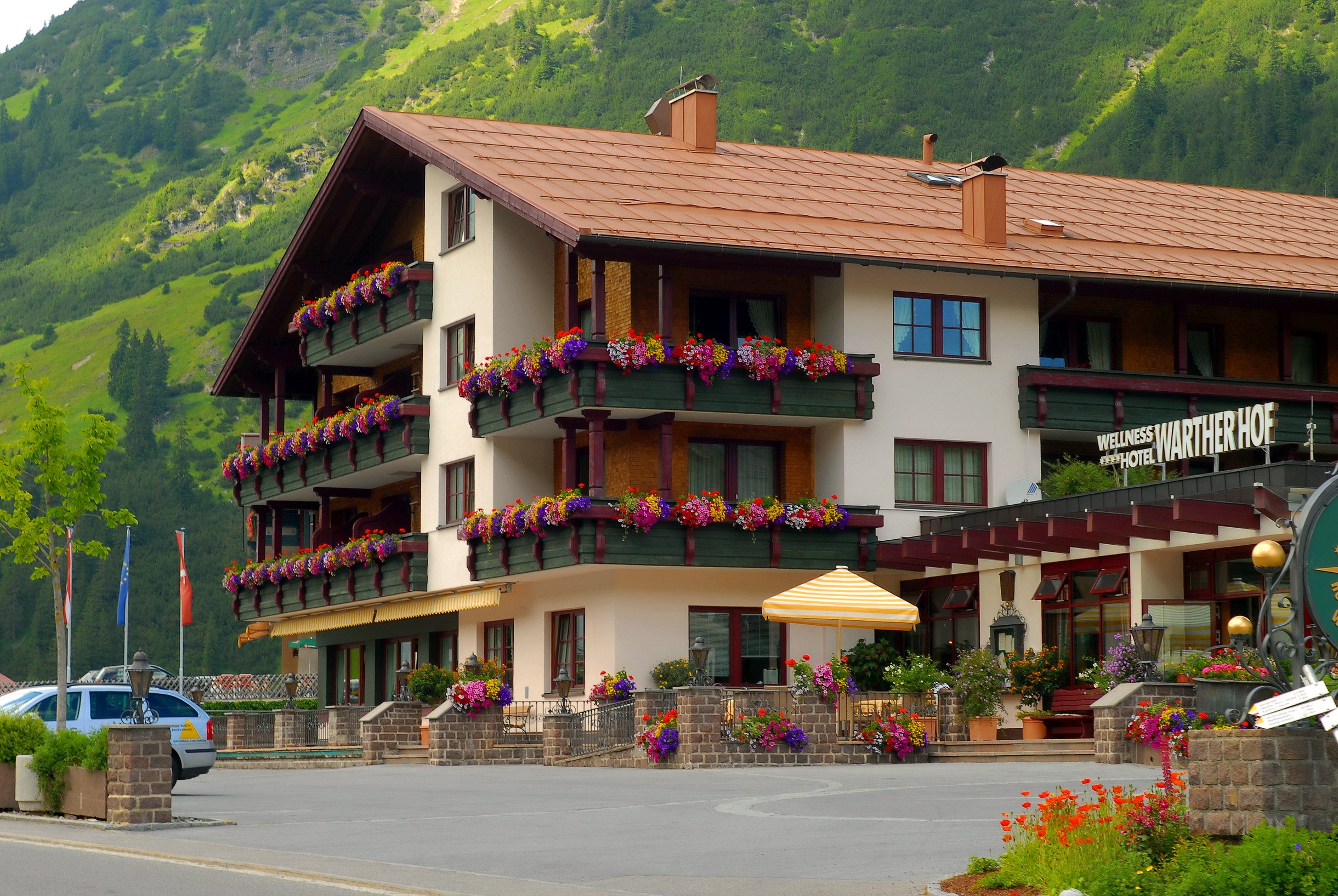 Hotel Warther Hof in Austria with mountain backdrop HD Wallpaper