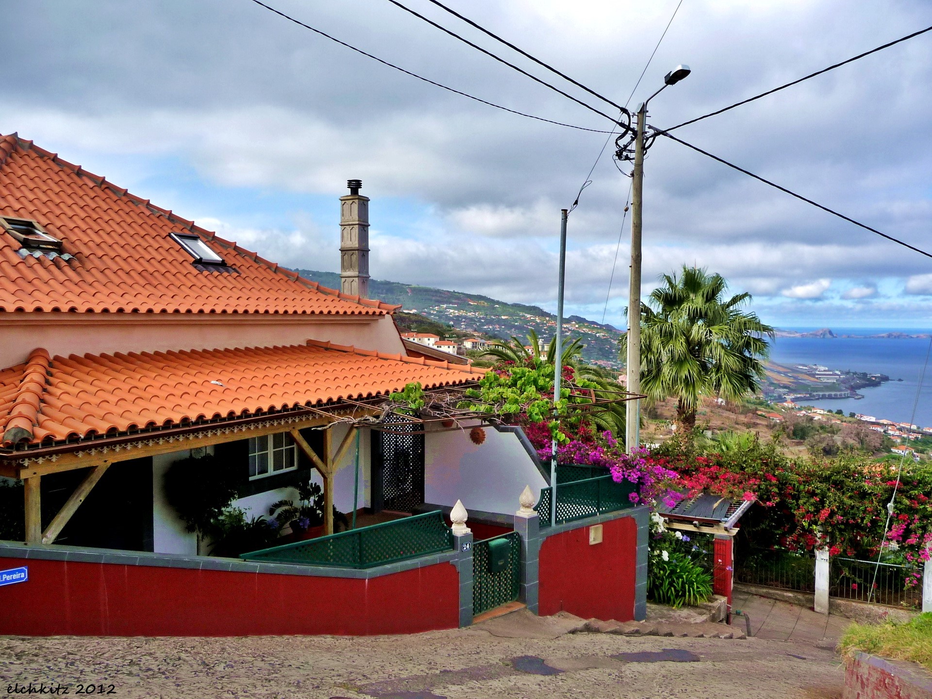 House with red walls and orange roof overlooking the sea HD Wallpaper