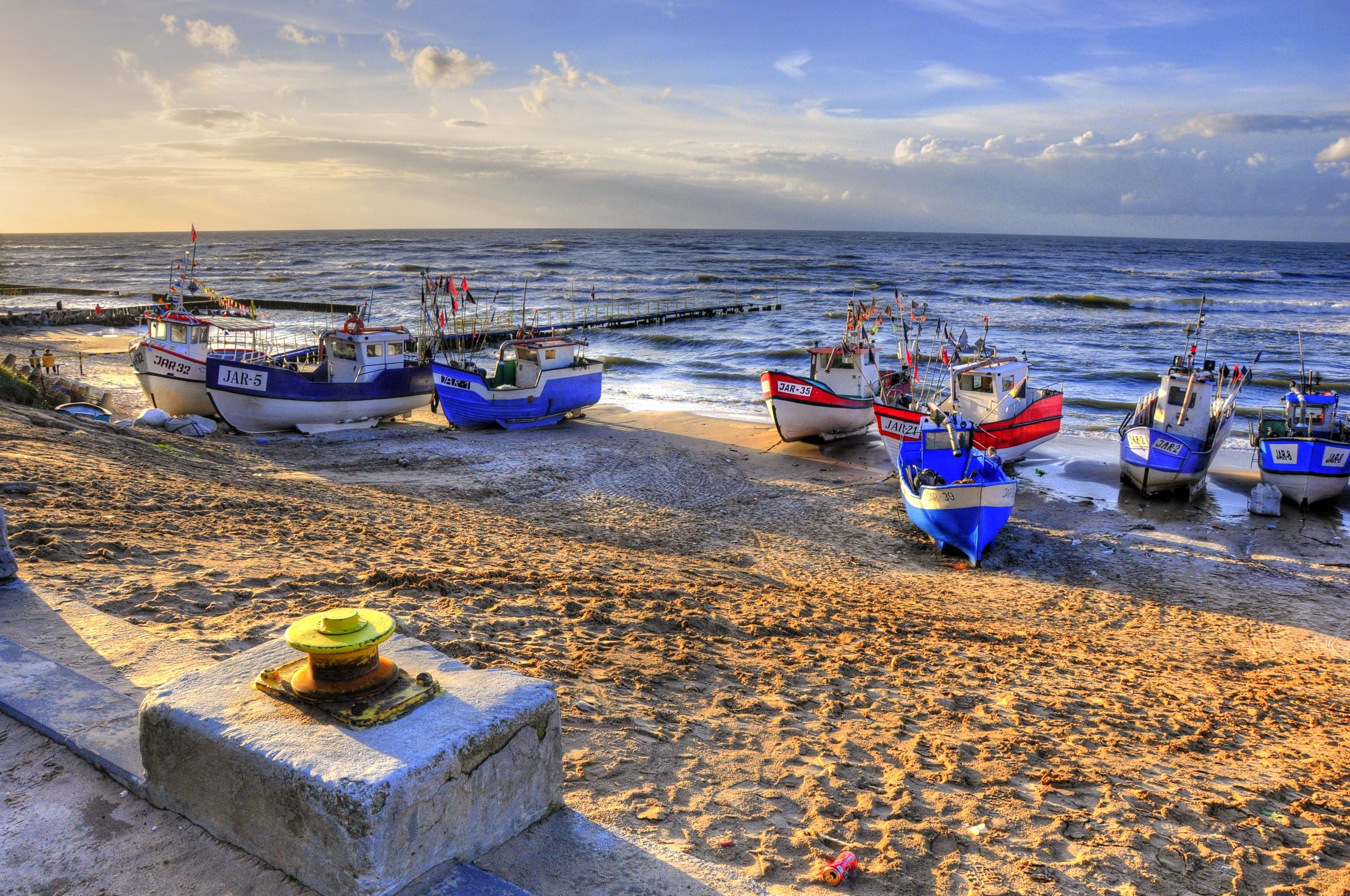 Fishing boats on a sandy beach by the sea HD Wallpaper