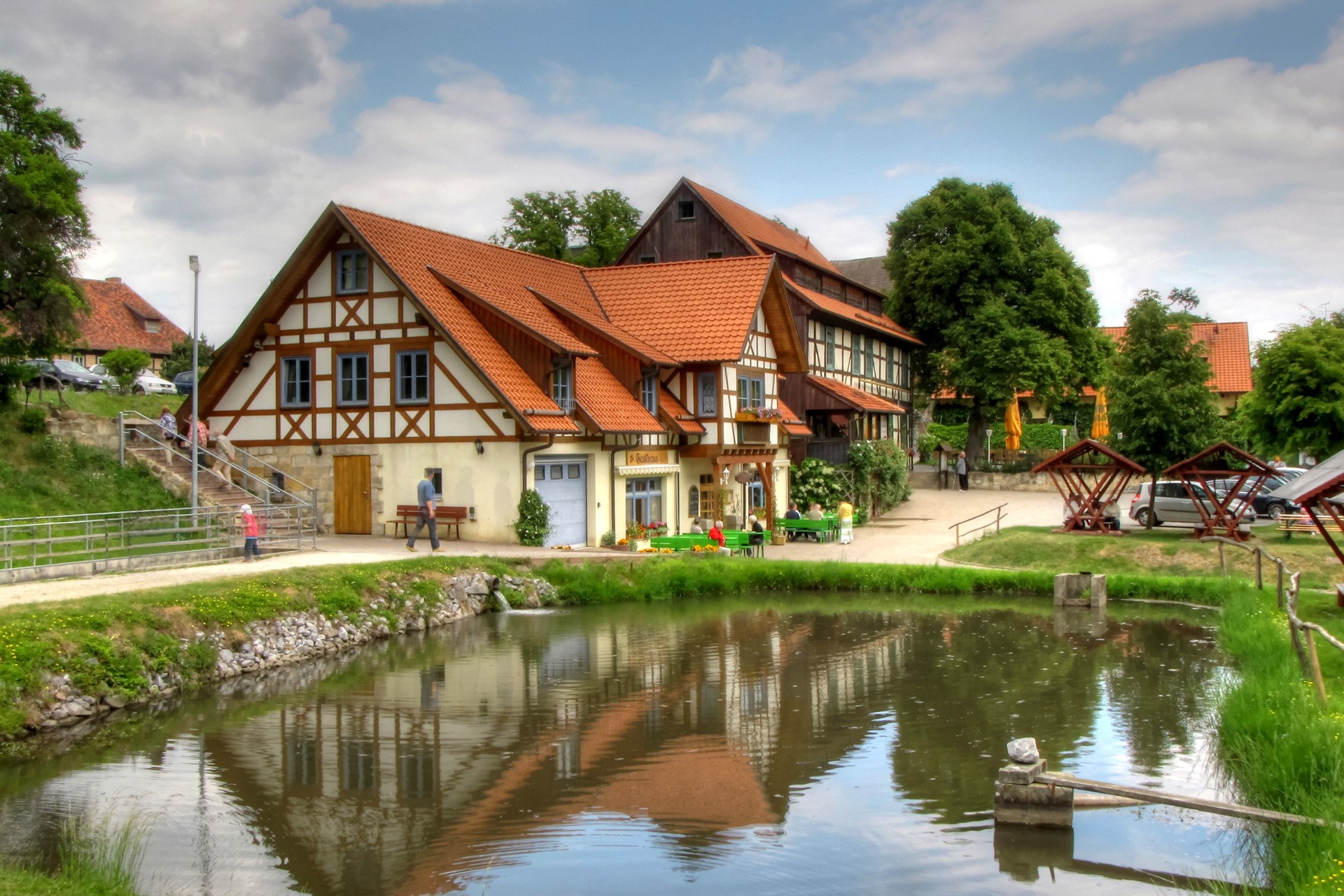 Half-timbered buildings by a pond in Germany HD Wallpaper