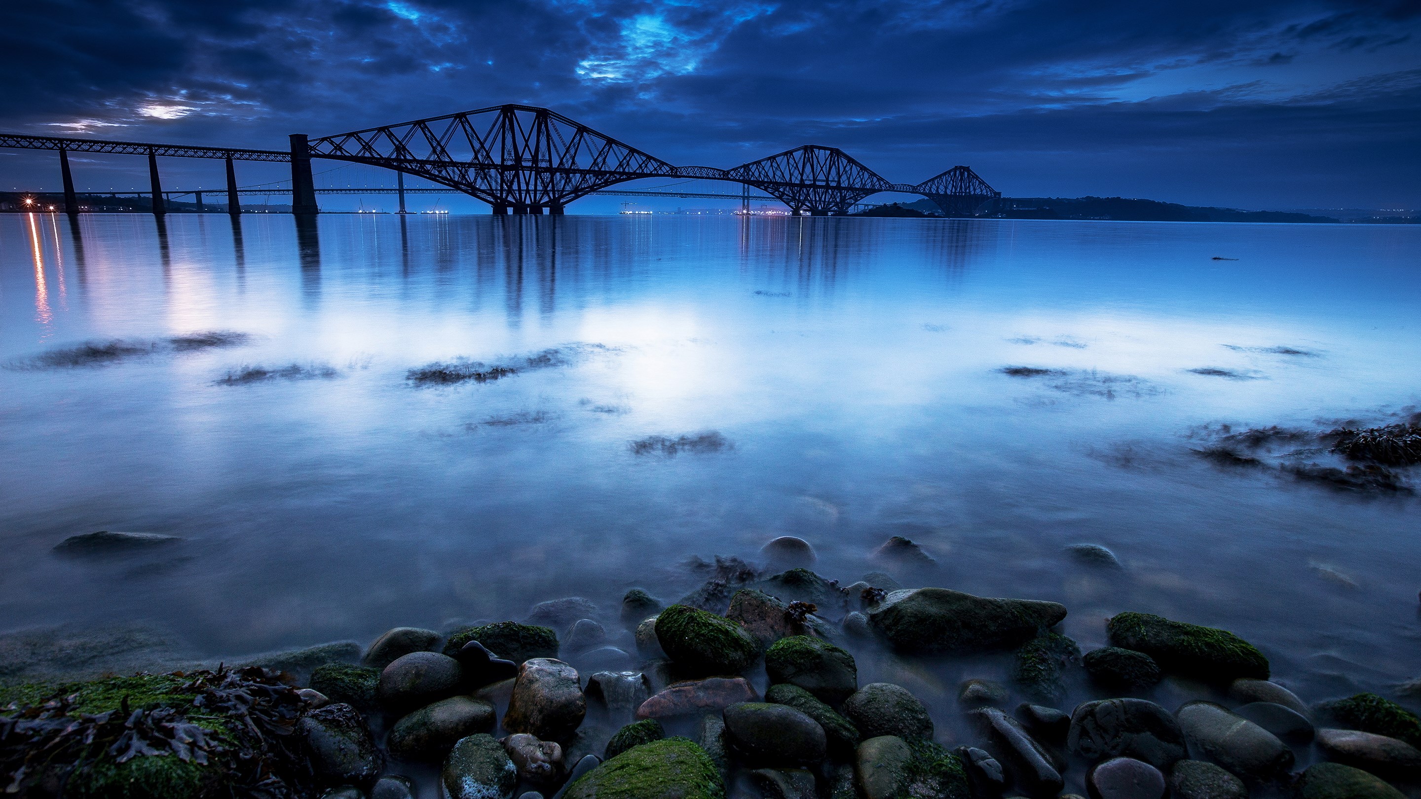 Forth Bridge at dusk over calm water HD Wallpaper