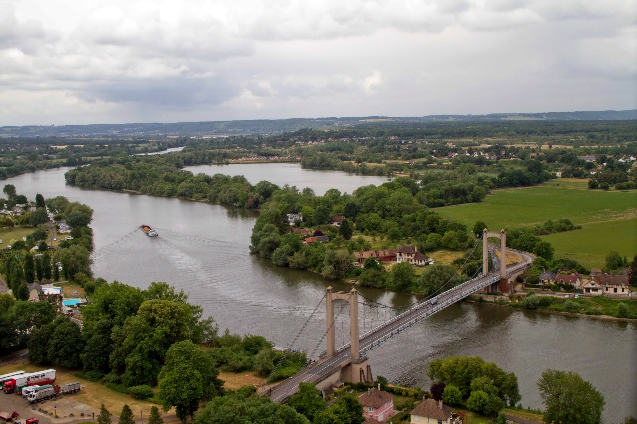 Bridge over a wide river with a barge HD Wallpaper