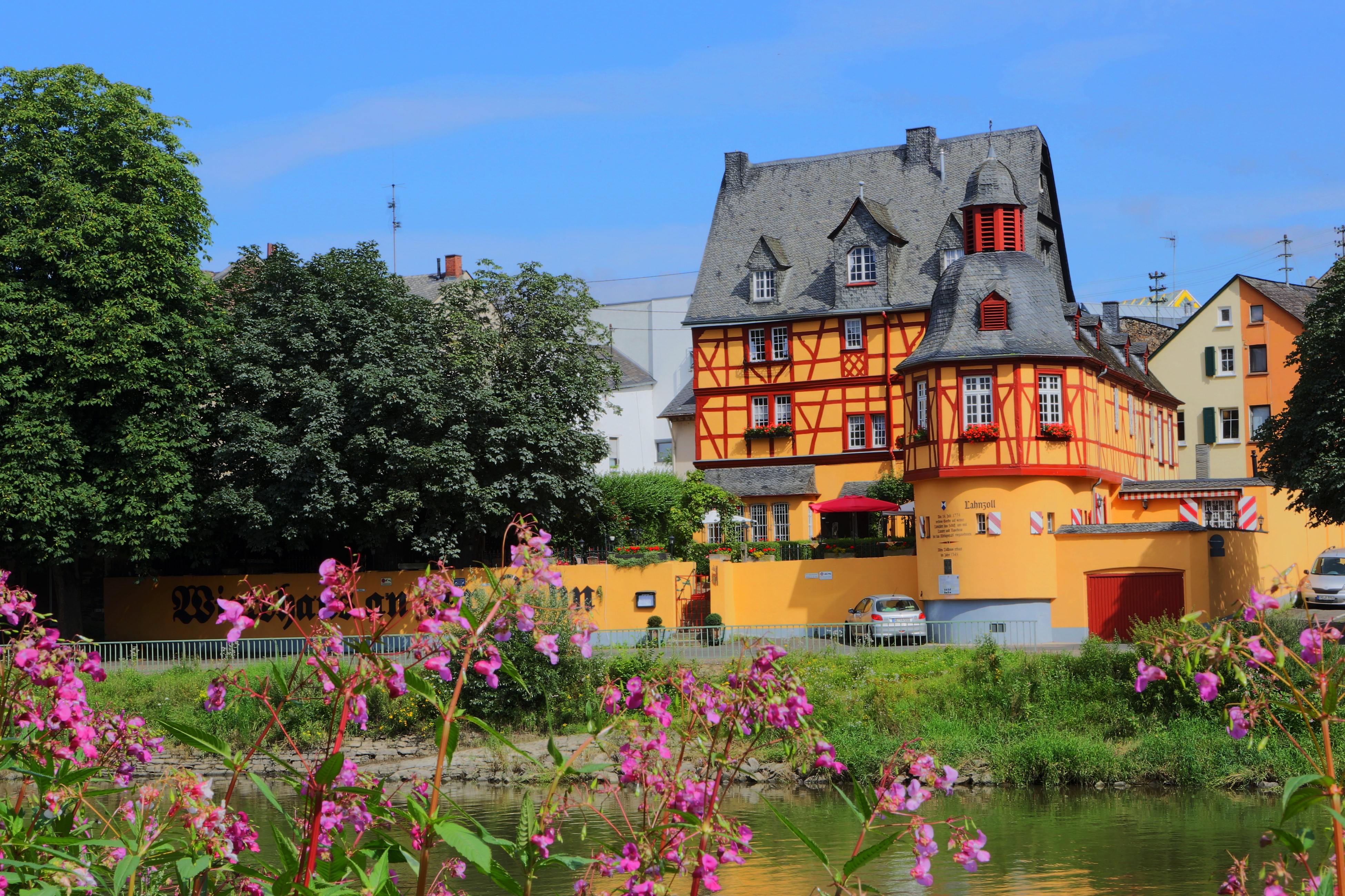 Half-timbered buildings by a river in Germany HD Wallpaper