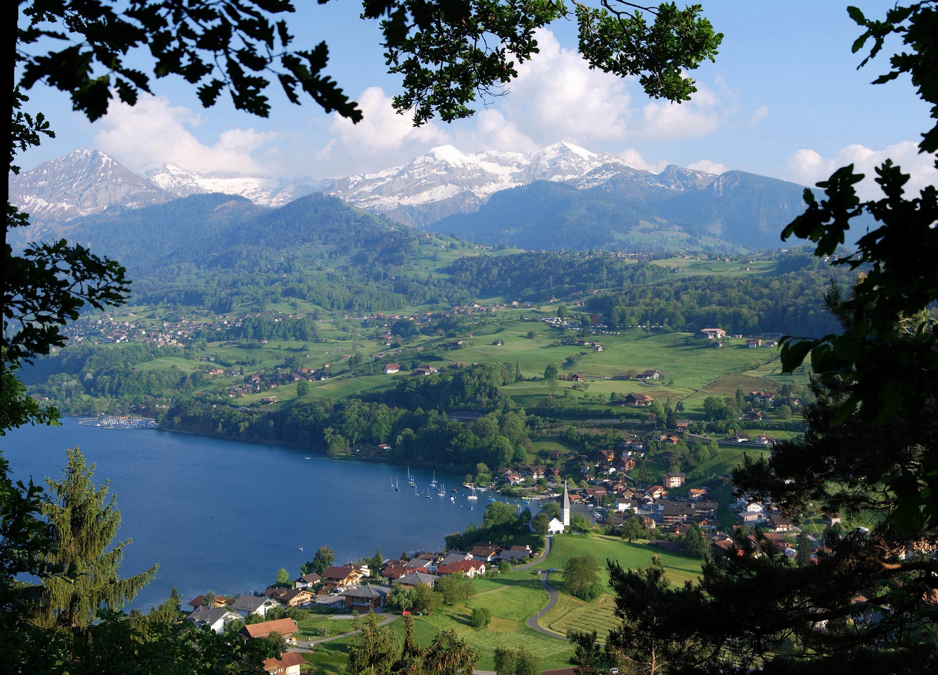 Village on a lake with snow-capped mountains in Switzerland HD Wallpaper
